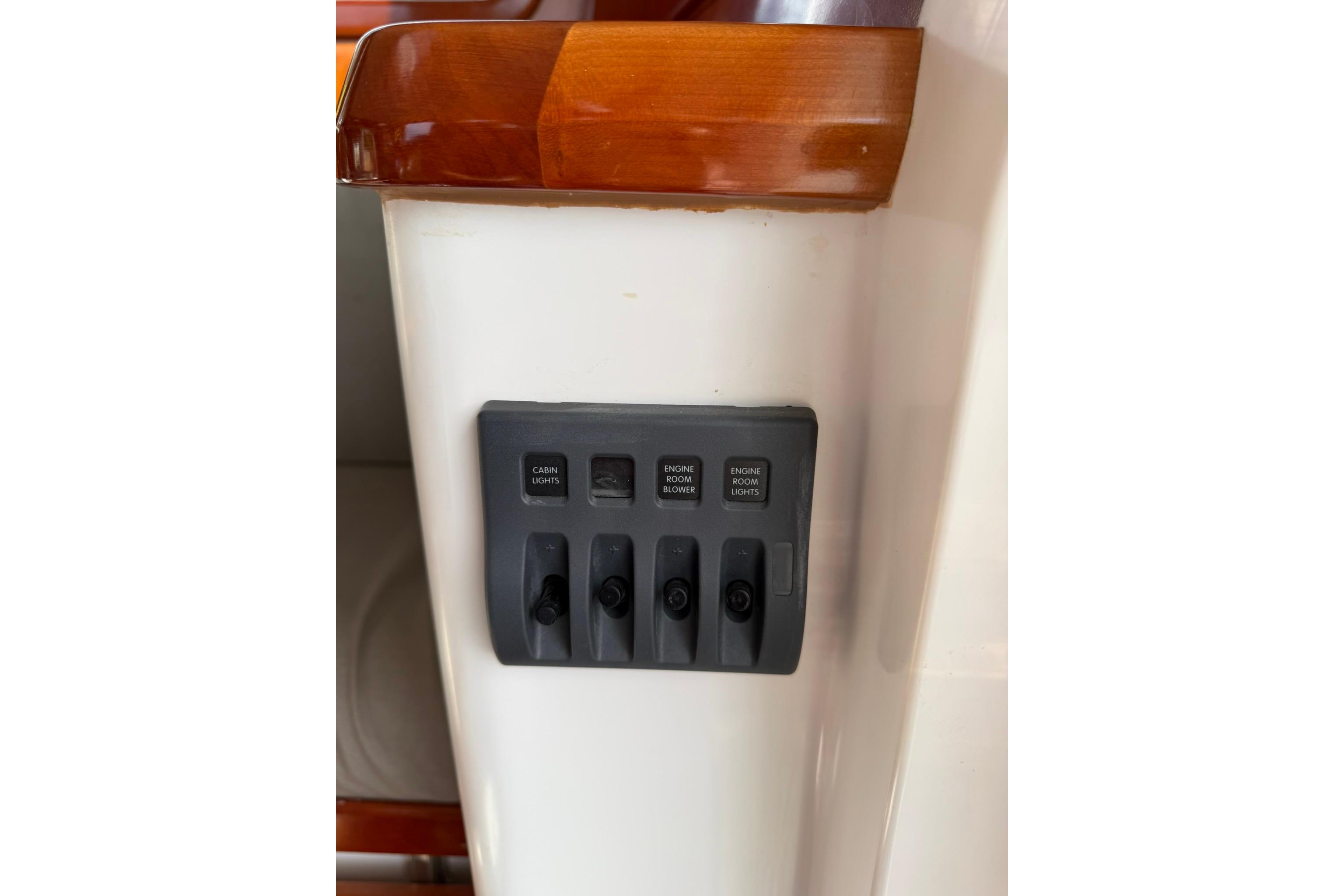 Control panel on 2020 SeaPiper 35 boat with switches for cabin and engine room lights.
