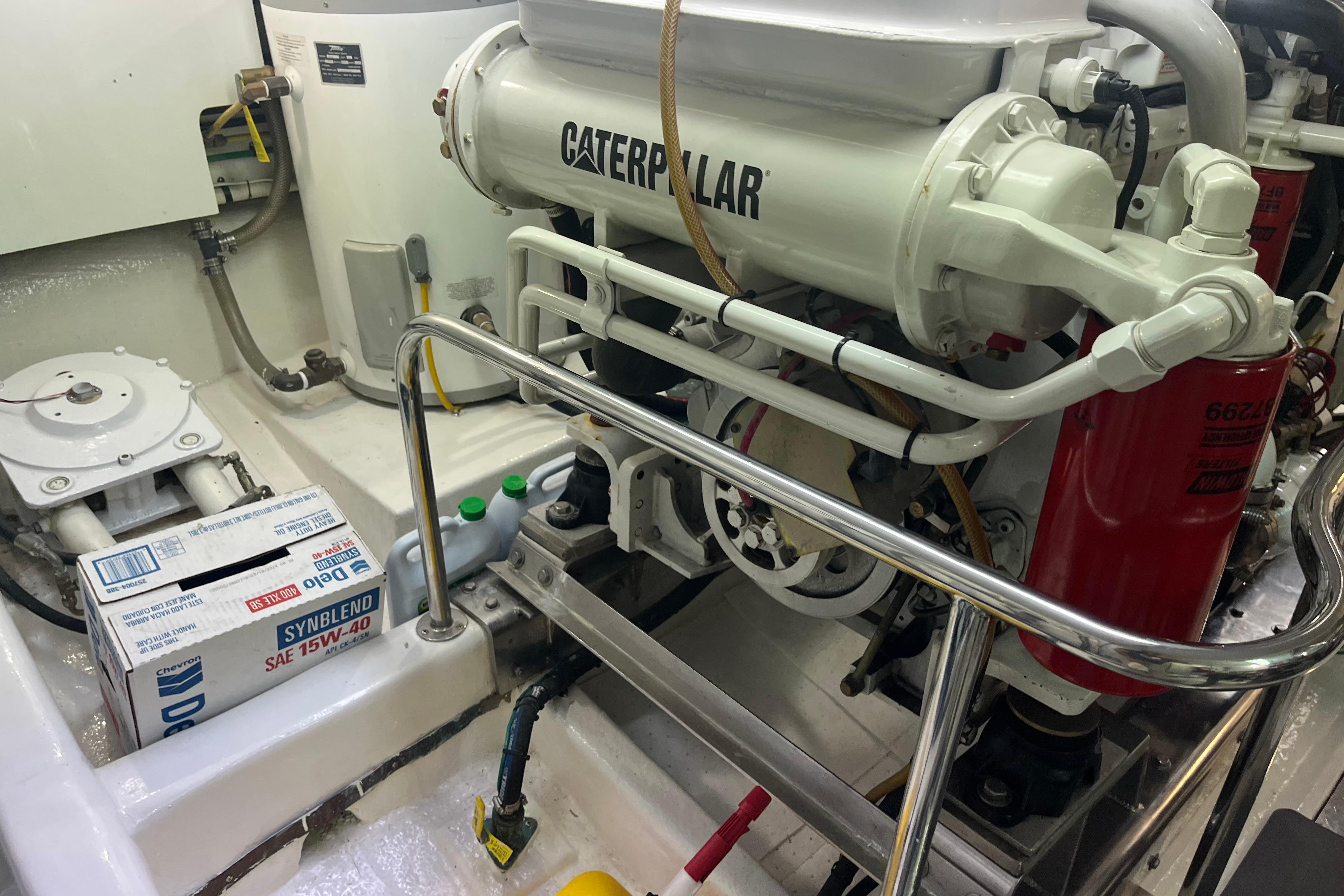 Engine room of 2004 Ocean Alexander 64 Pilothouse with Caterpillar engine and maintenance supplies.