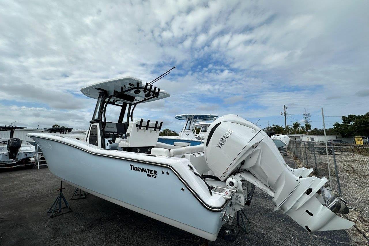 2026 Tidewater 272 LXF boat with Yamaha engine, parked outdoors under cloudy sky.