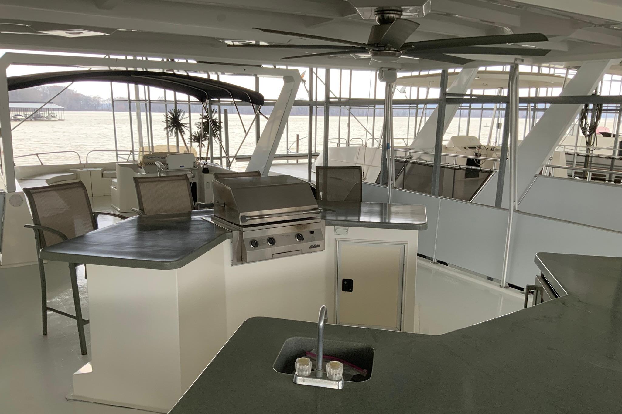 Luxurious 2004 Sumerset 18 x 87 houseboat with outdoor kitchen and scenic water views.