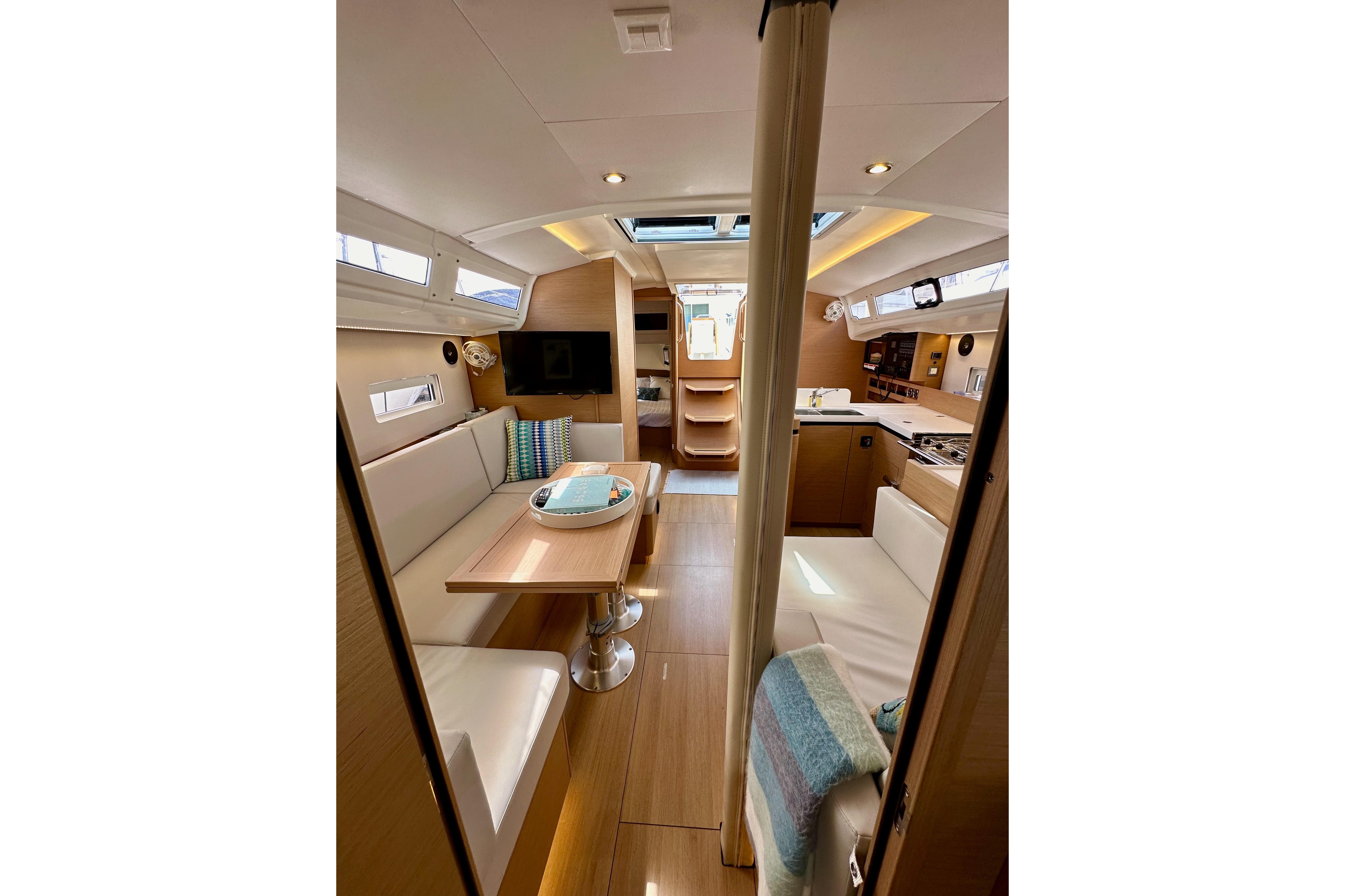 Interior of 2024 Jeanneau Sun Odyssey 410 yacht, featuring modern design and cozy seating.