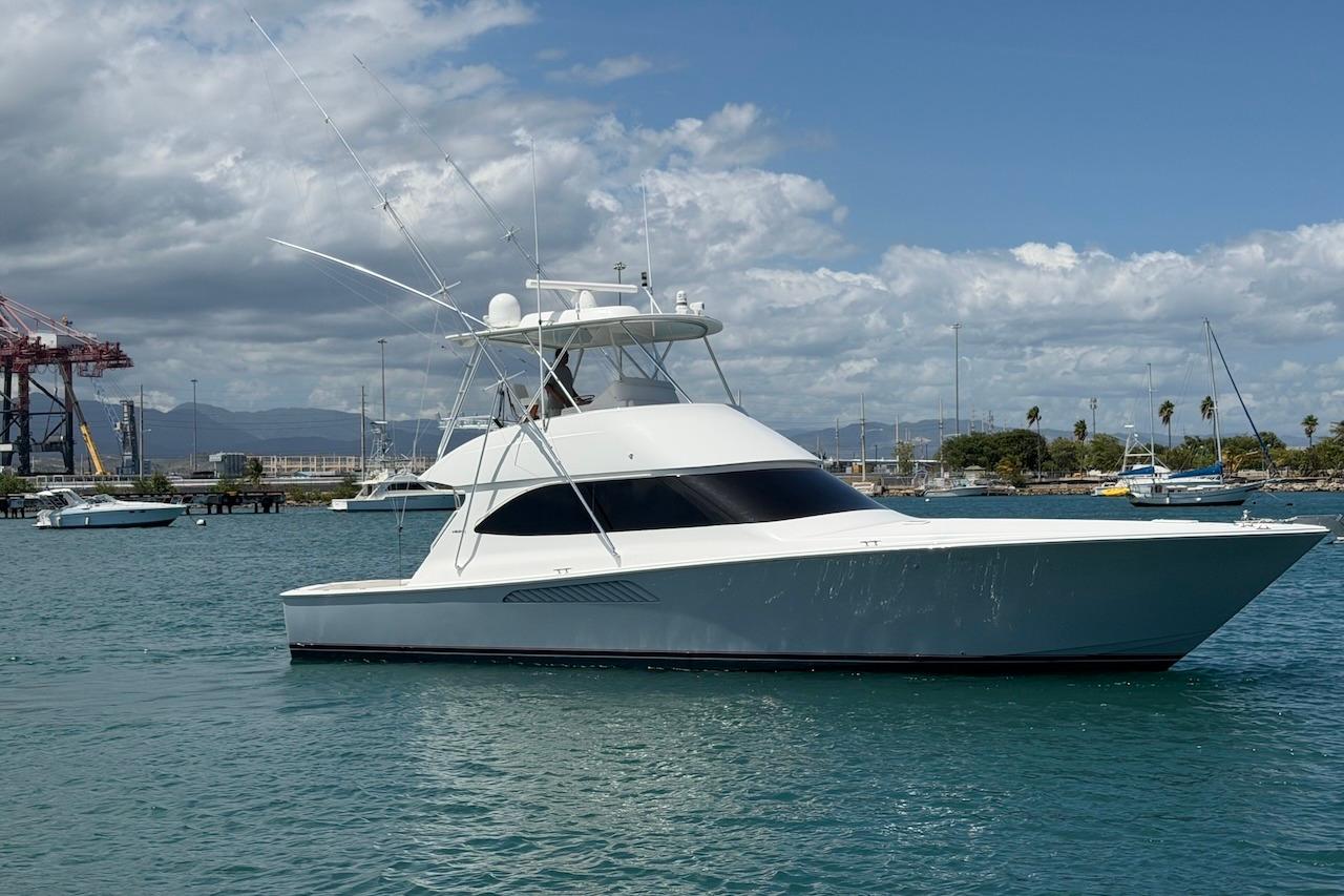 2012 Viking 50 Convertible yacht on calm waters under a partly cloudy sky.