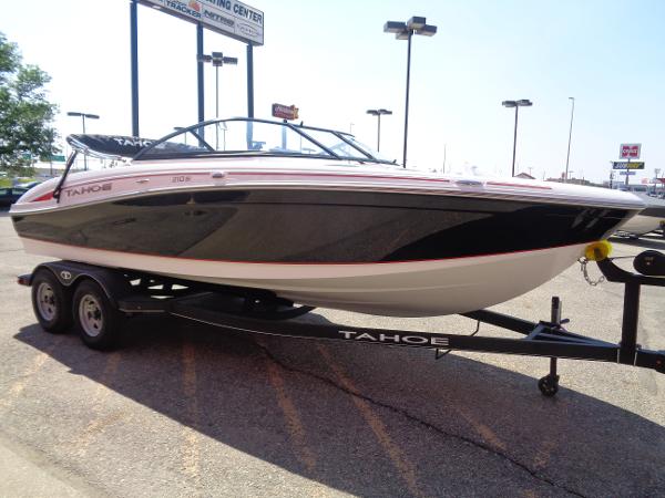 2023 Tahoe 210 Si boat on trailer in parking lot.