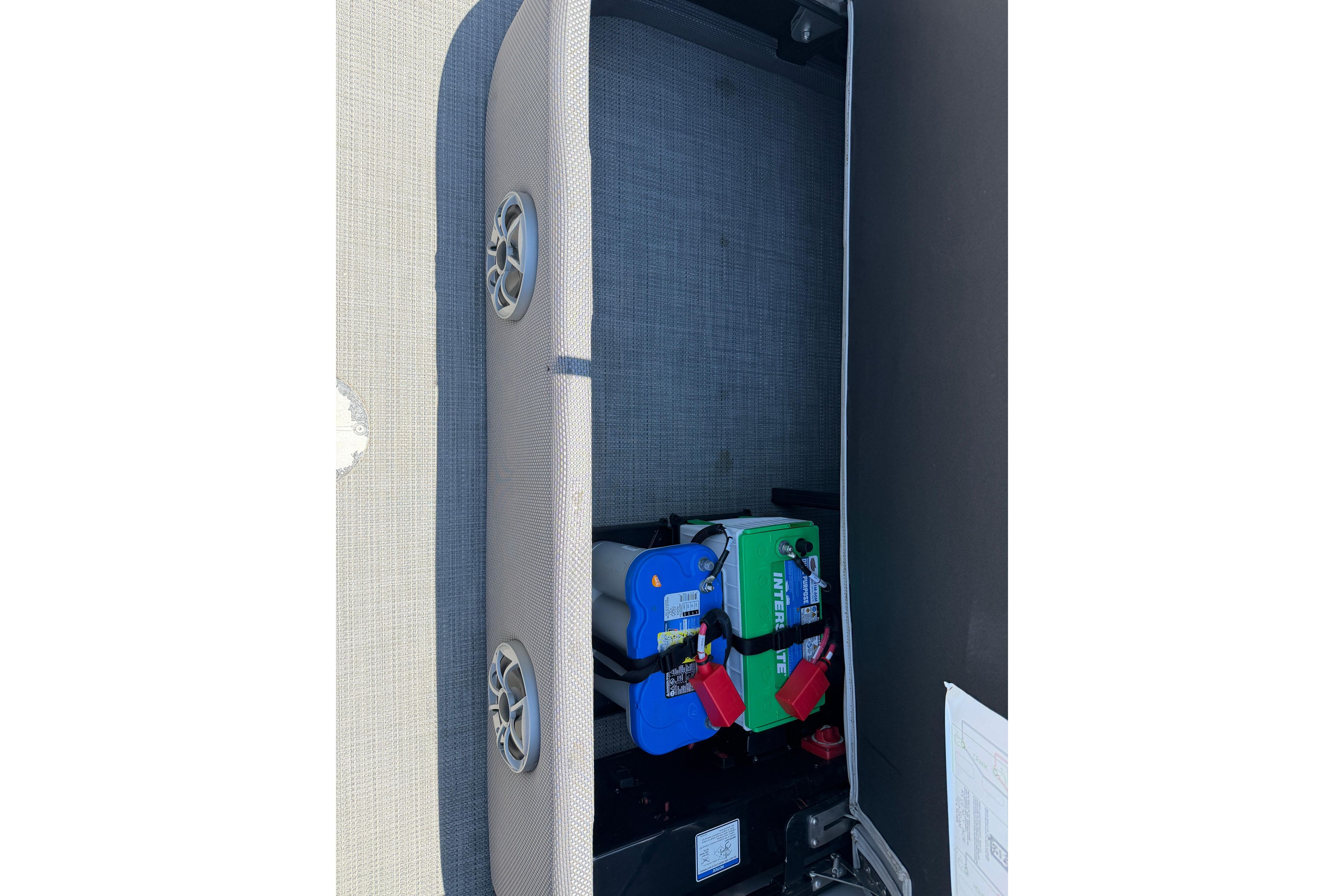 2024 Regency R250DL3 boat battery compartment with Interstate batteries and speaker.