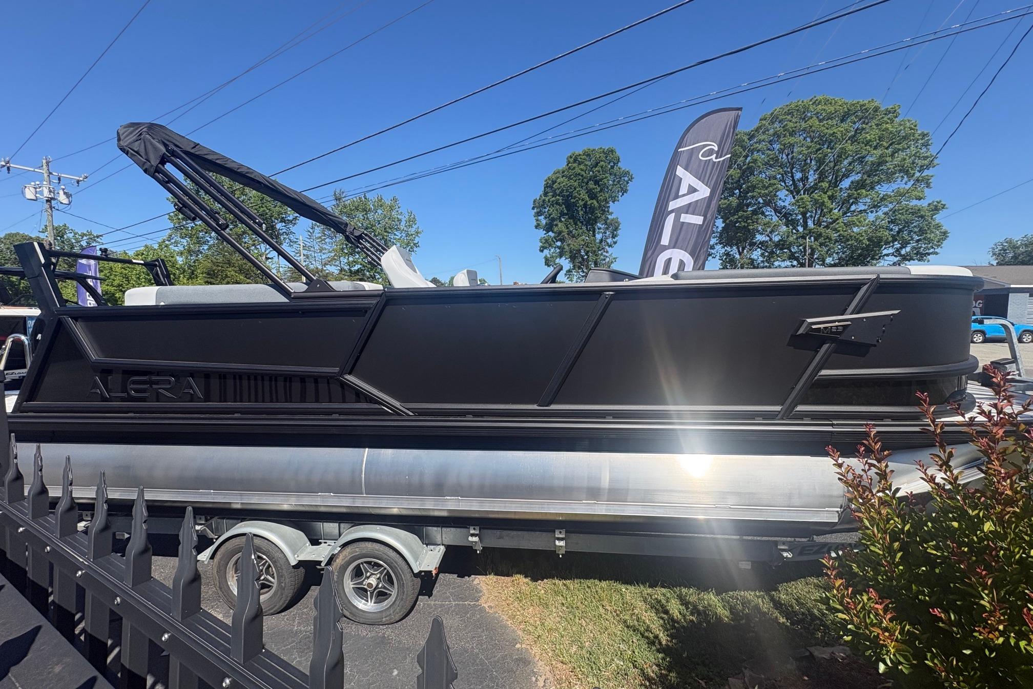 2026 Alera 23Q pontoon boat on trailer, displayed outdoors under clear blue sky.