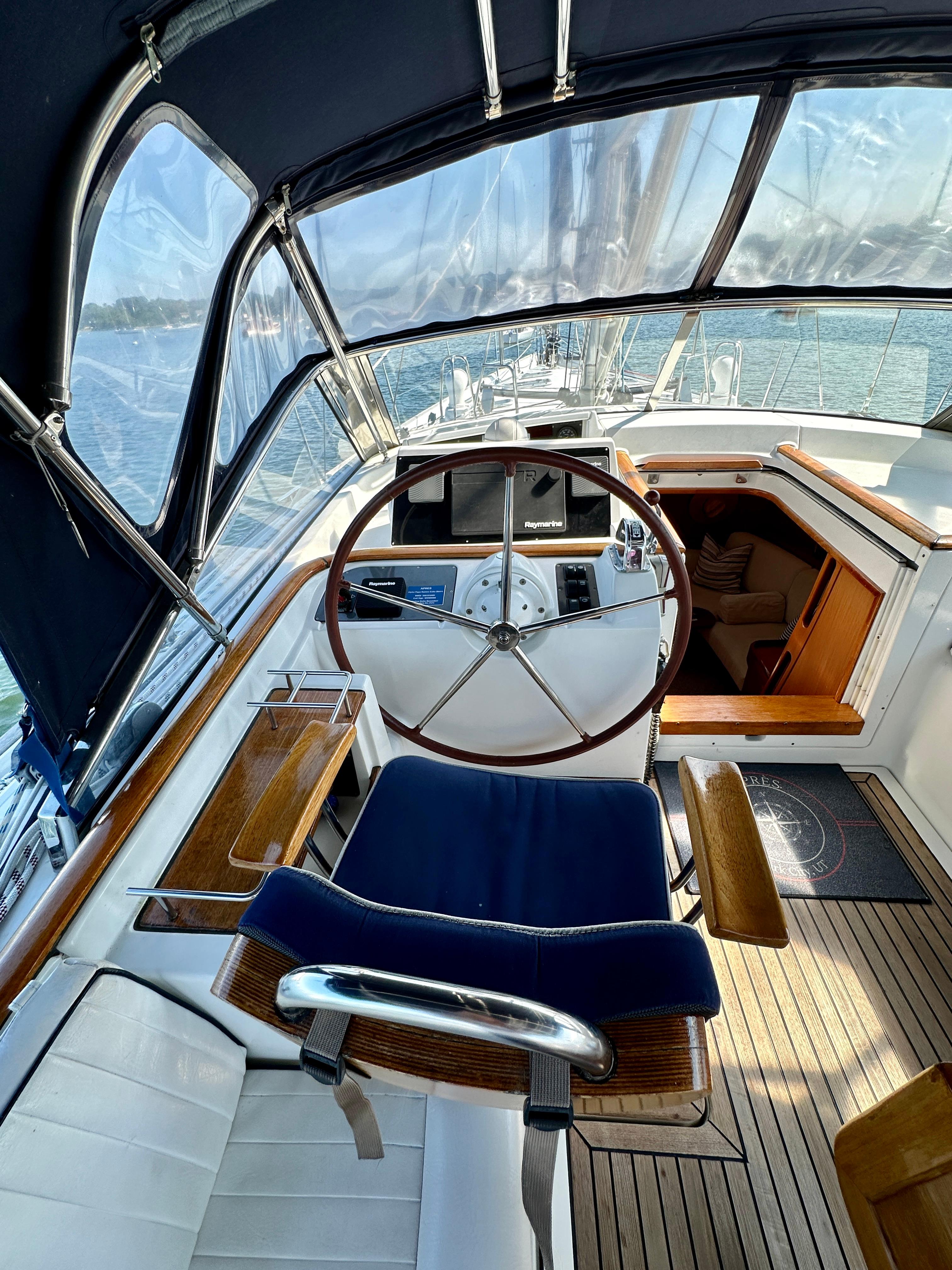 Cockpit of 2010 Beneteau 57 sailboat with wooden accents and steering wheel.