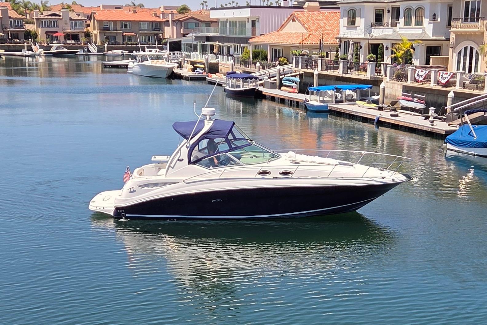 2006 Sea Ray Sundancer 320 yacht docked in a scenic marina setting.