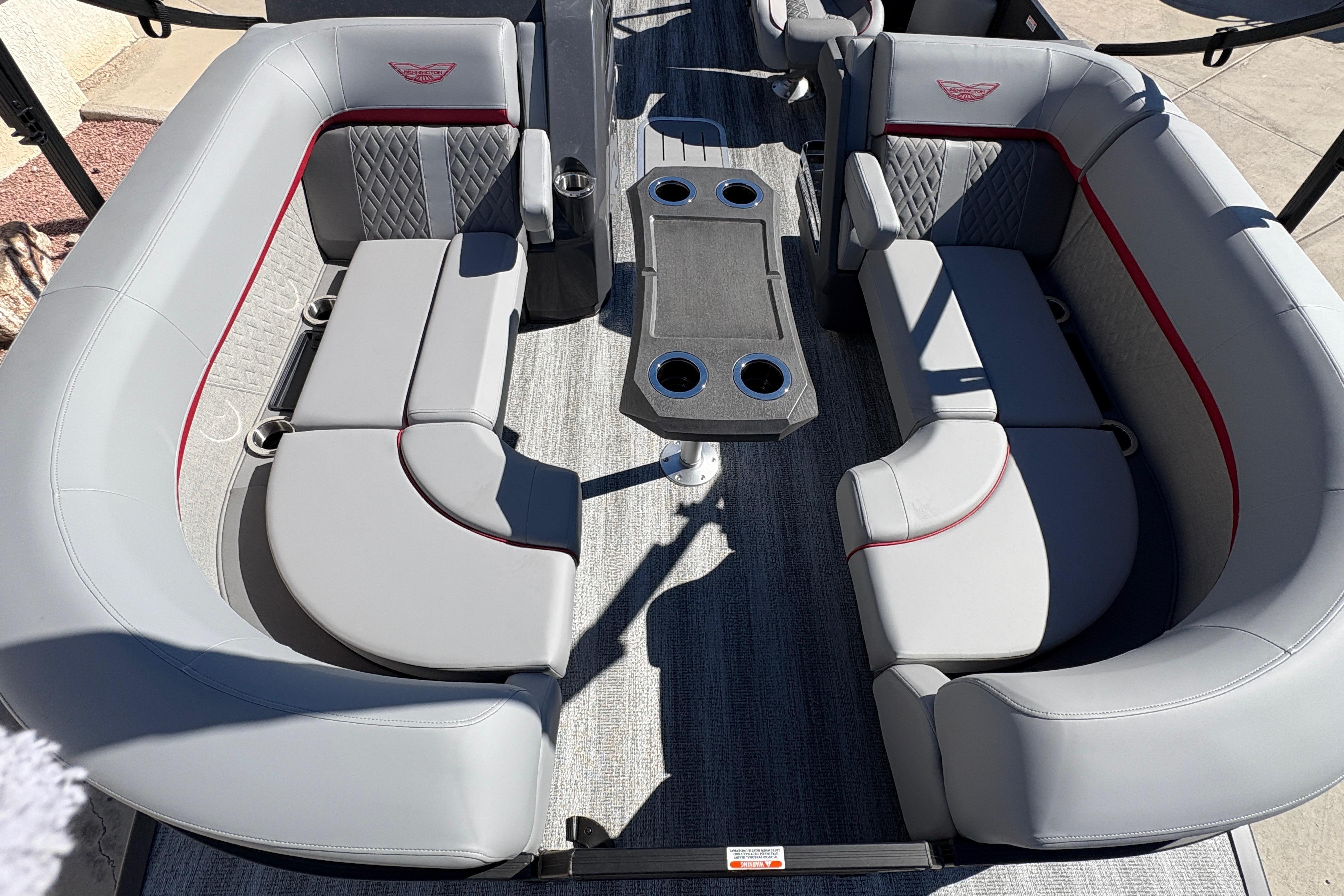2026 Bennington 22 MFB boat interior with gray seating and central table.