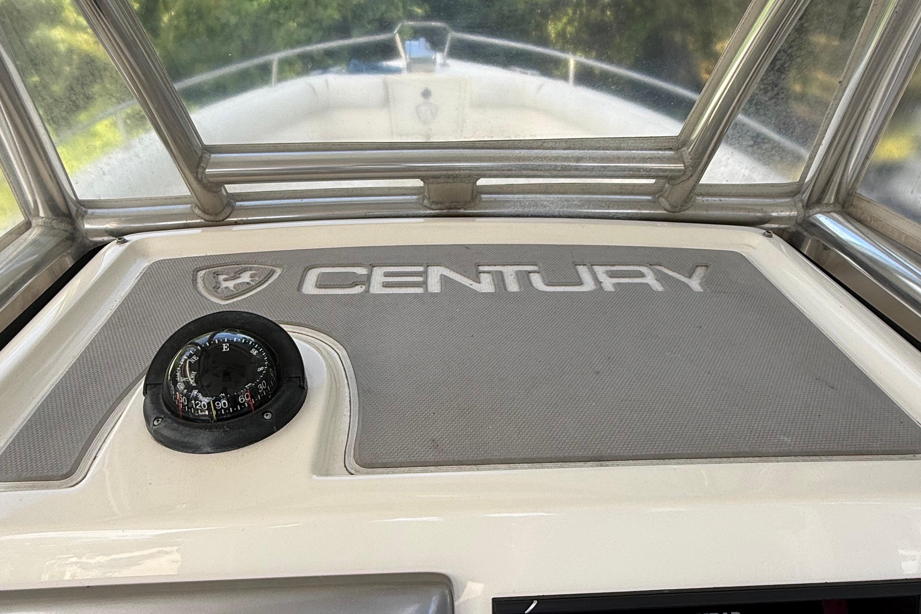 2008 Century 2901 Center Console boat dashboard with compass and logo.