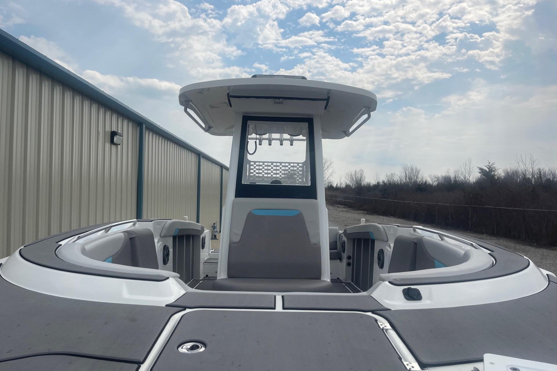 2025 Hurricane Center Console 24 OB boat with sleek design, docked under a cloudy sky.