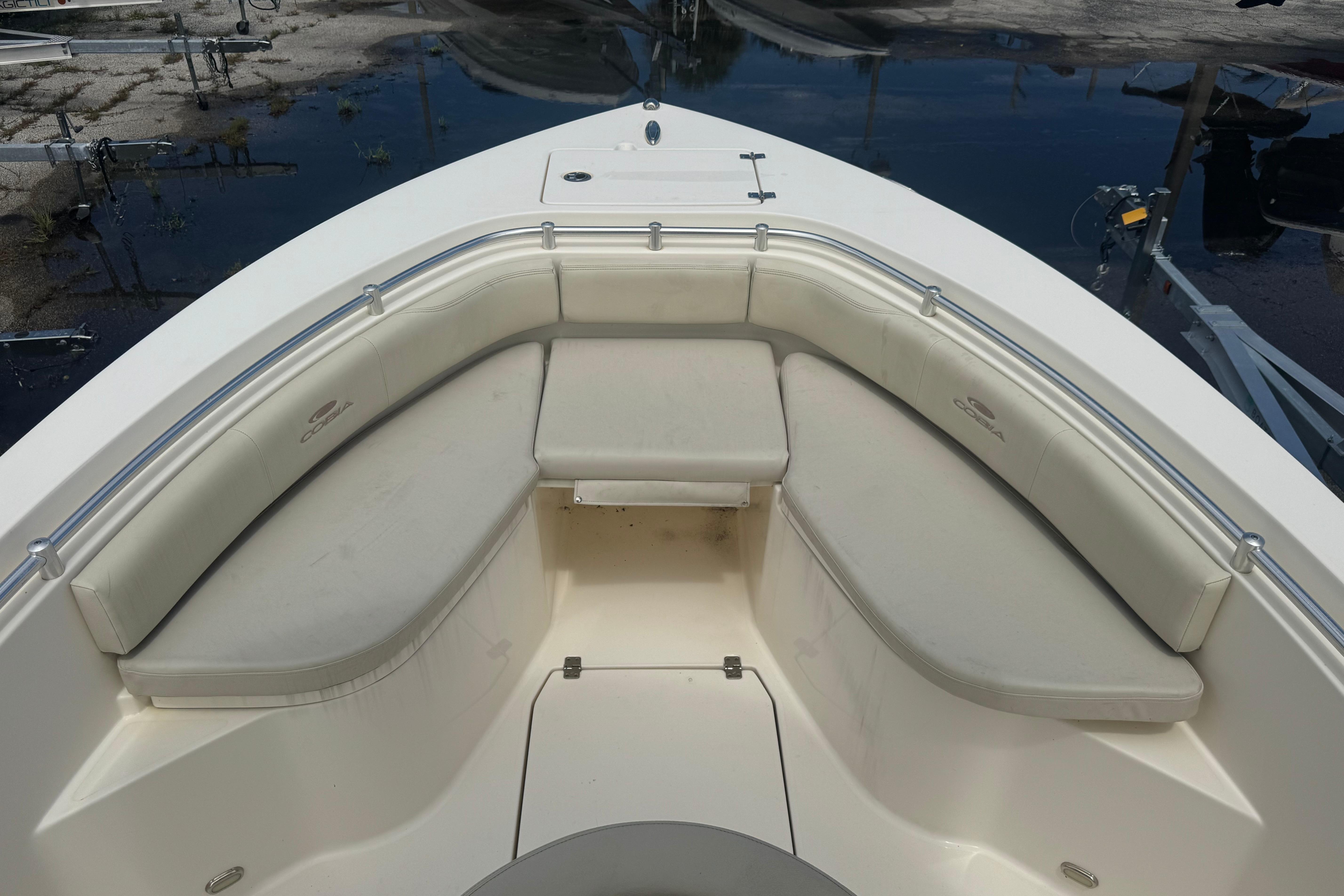 2022 Cobia 237 Center Console boat with cushioned seating area.