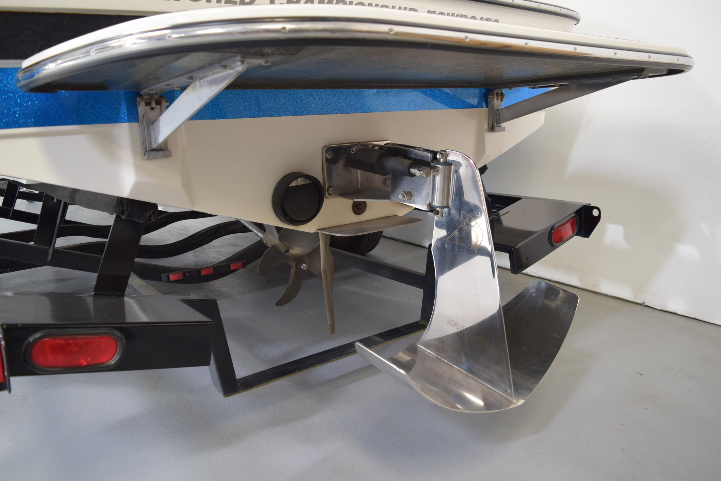 Rear view of a 2007 Centurion SV 240 boat on a trailer, showcasing the propeller and rudder.