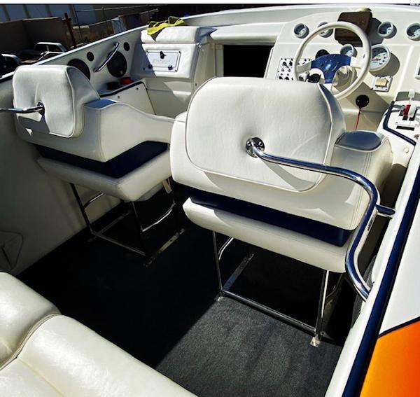 2001 Eliminator Eagle boat interior with white leather seats and modern dashboard.