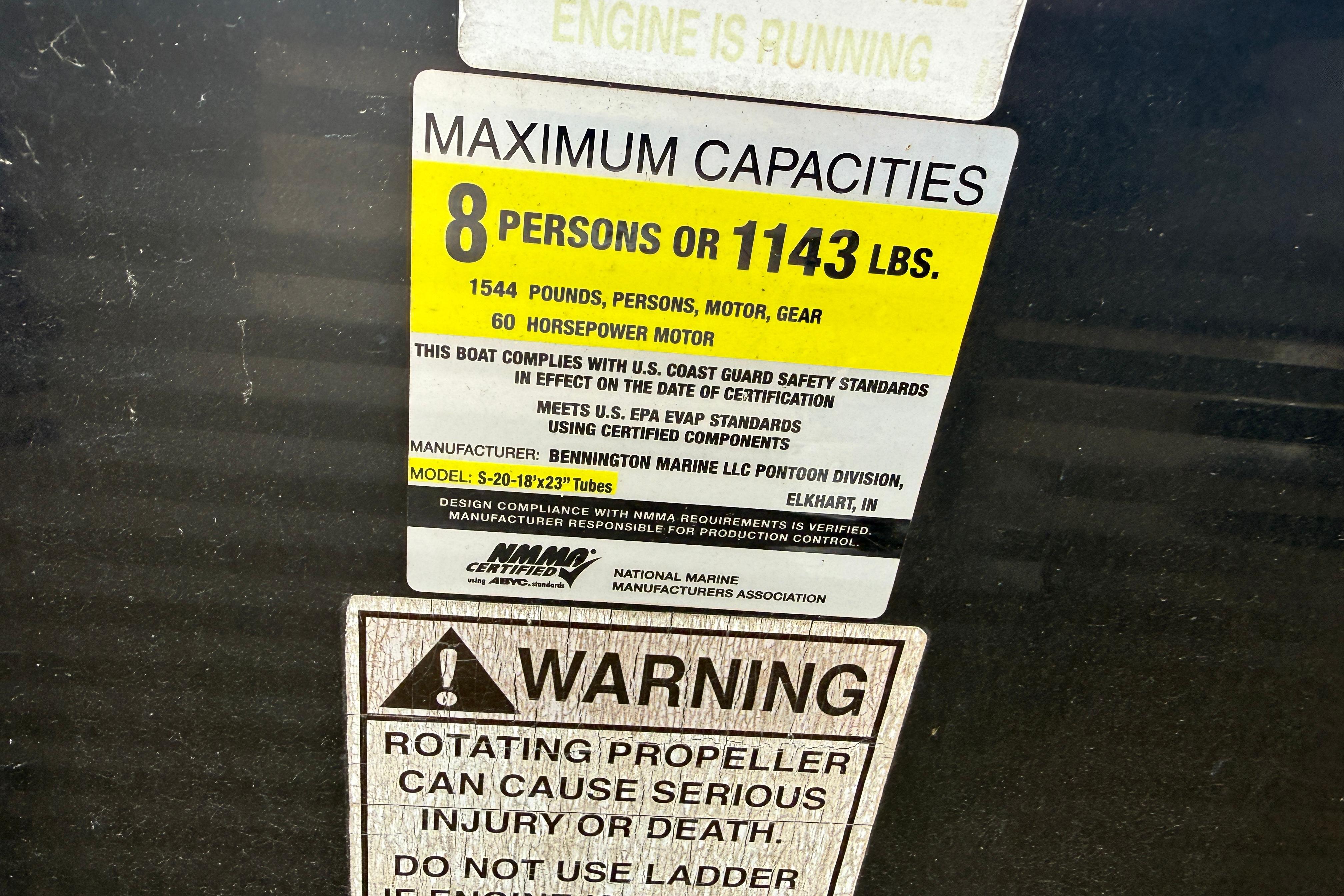 2010 Bennington 20SLi capacity label: 8 persons, 1143 lbs, 60 HP motor warning.
