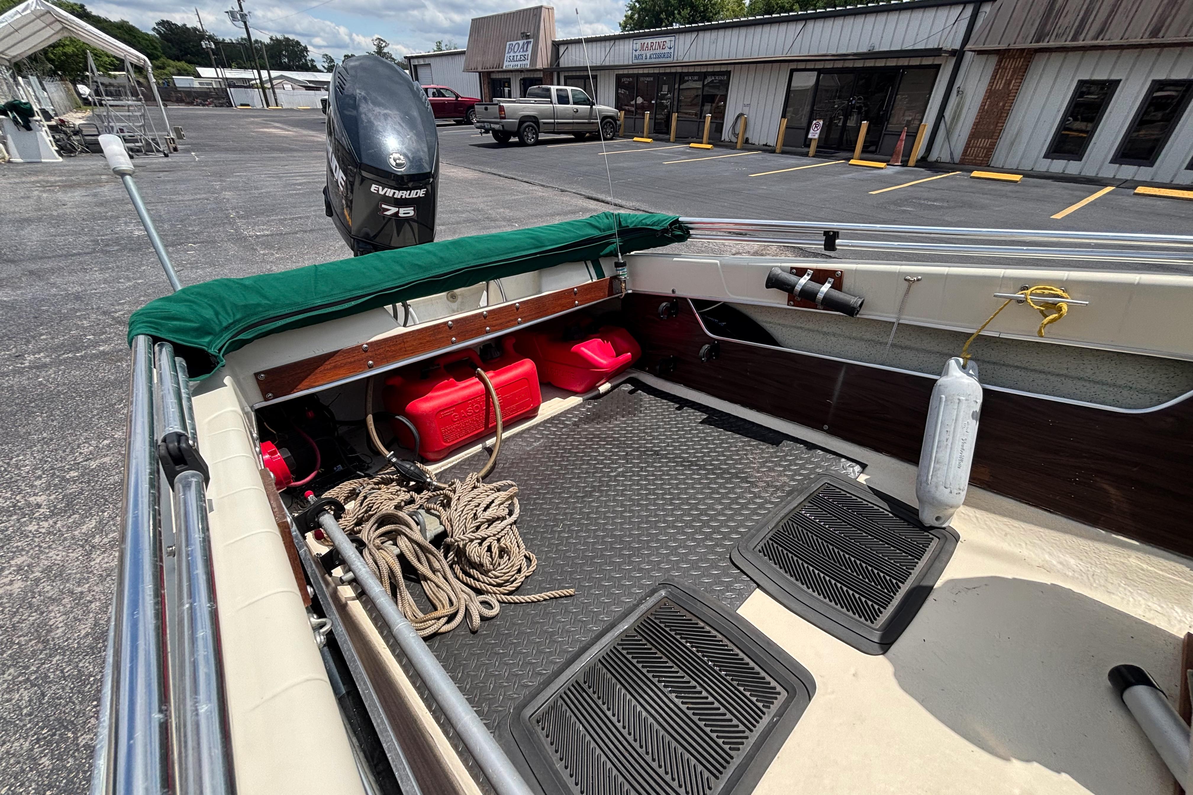 1966 Mohawk 15 boat interior with Evinrude motor, ropes, and fuel tanks.