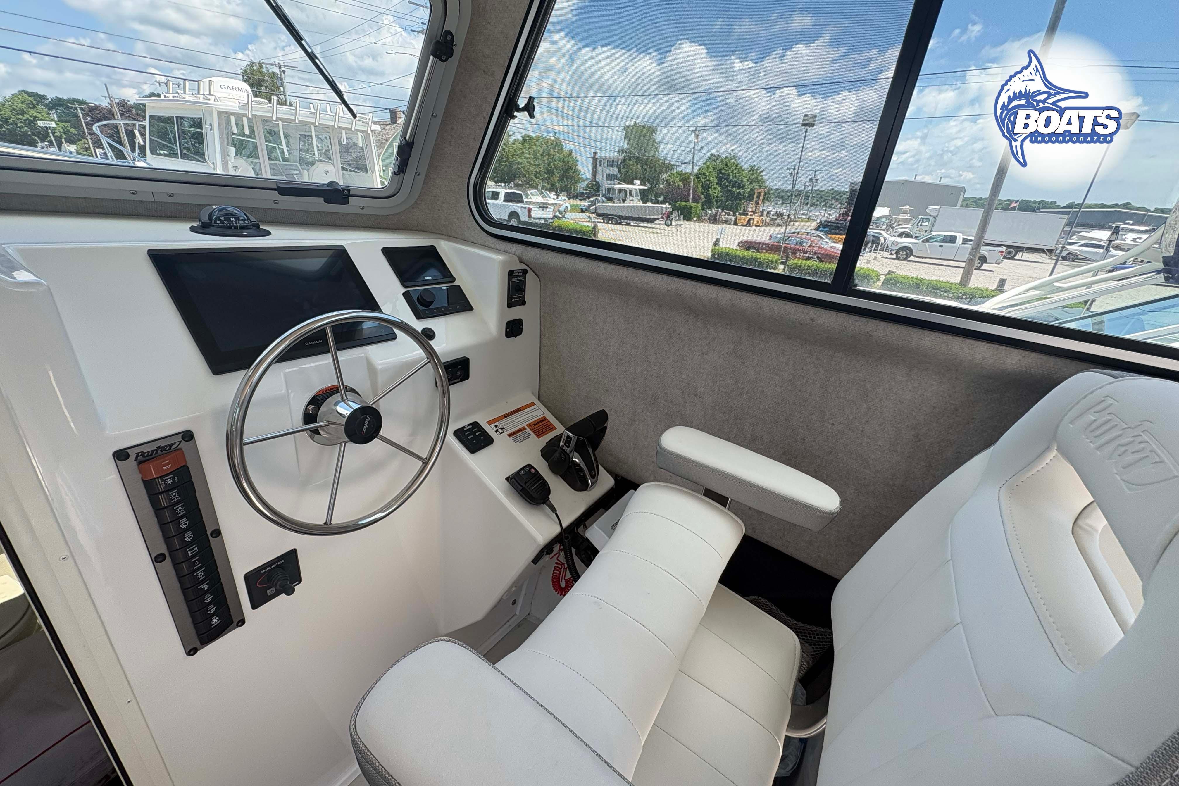 Interior of 2021 Parker 2520 XLD Sport Cabin with steering wheel and dashboard controls.