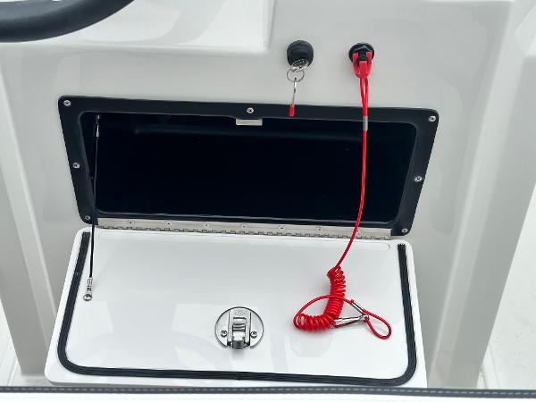 2025 Starcraft SVX 211 OB CC boat console with storage compartment and safety lanyard.