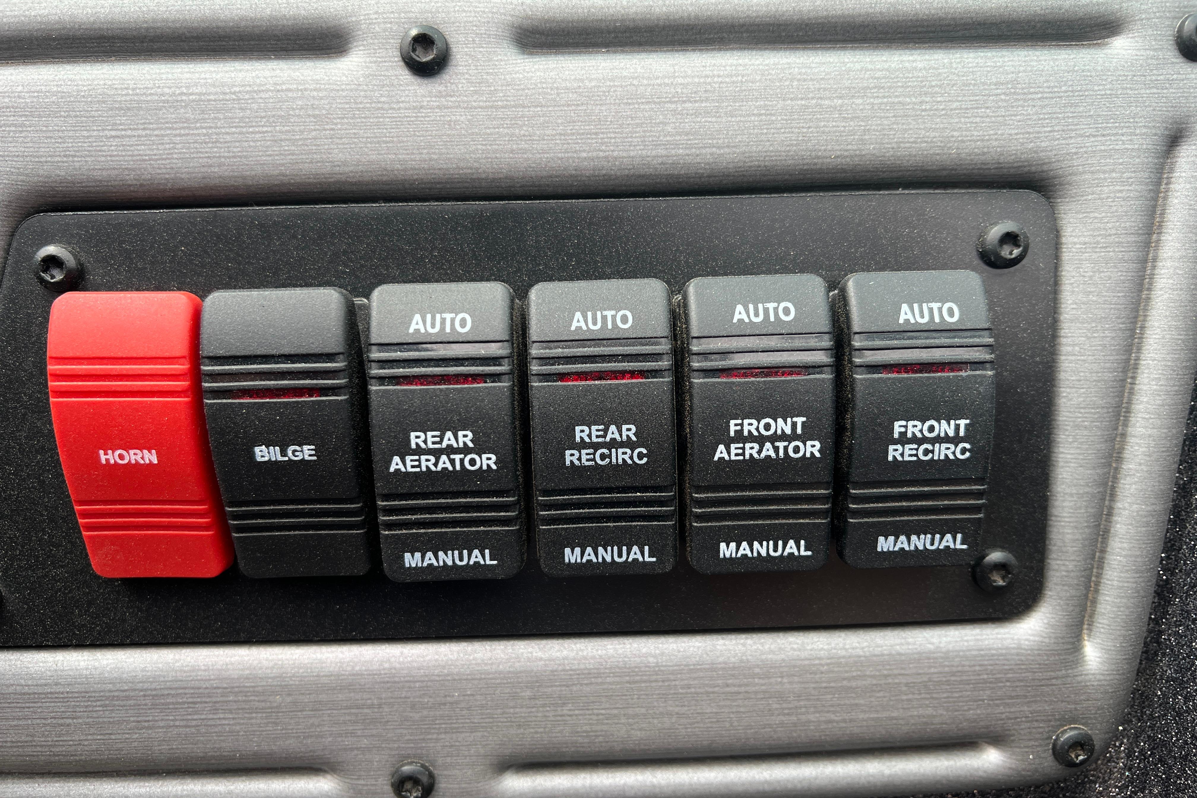 Control panel of 2026 Ranger VS1682SC Angler boat with switches for horn, bilge, and aerators.