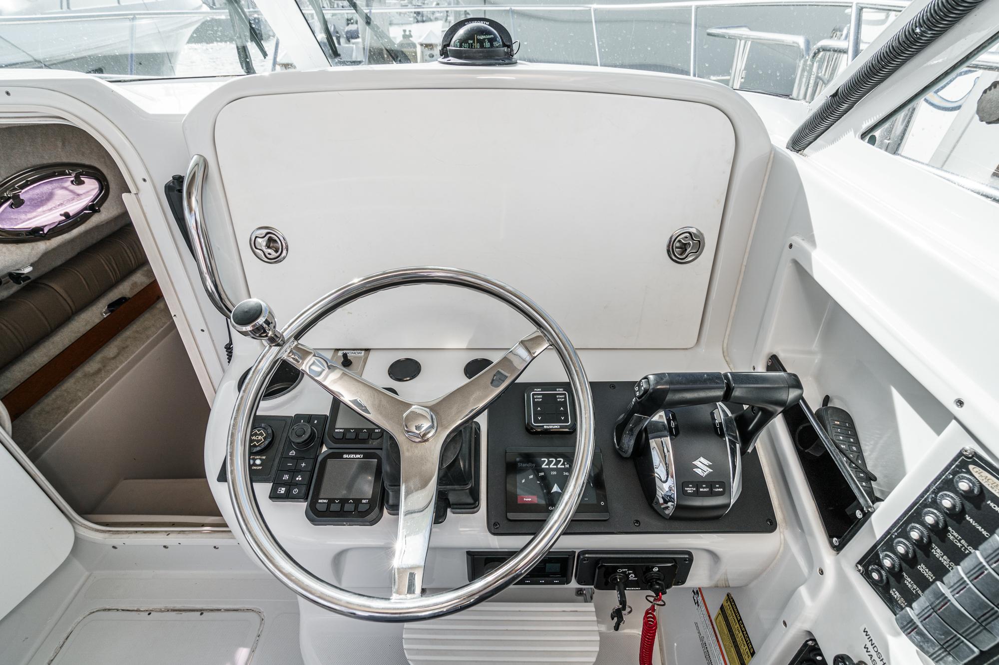 Helm of 2007 Glacier Bay 2680 Coastal Runner with steering wheel and controls.