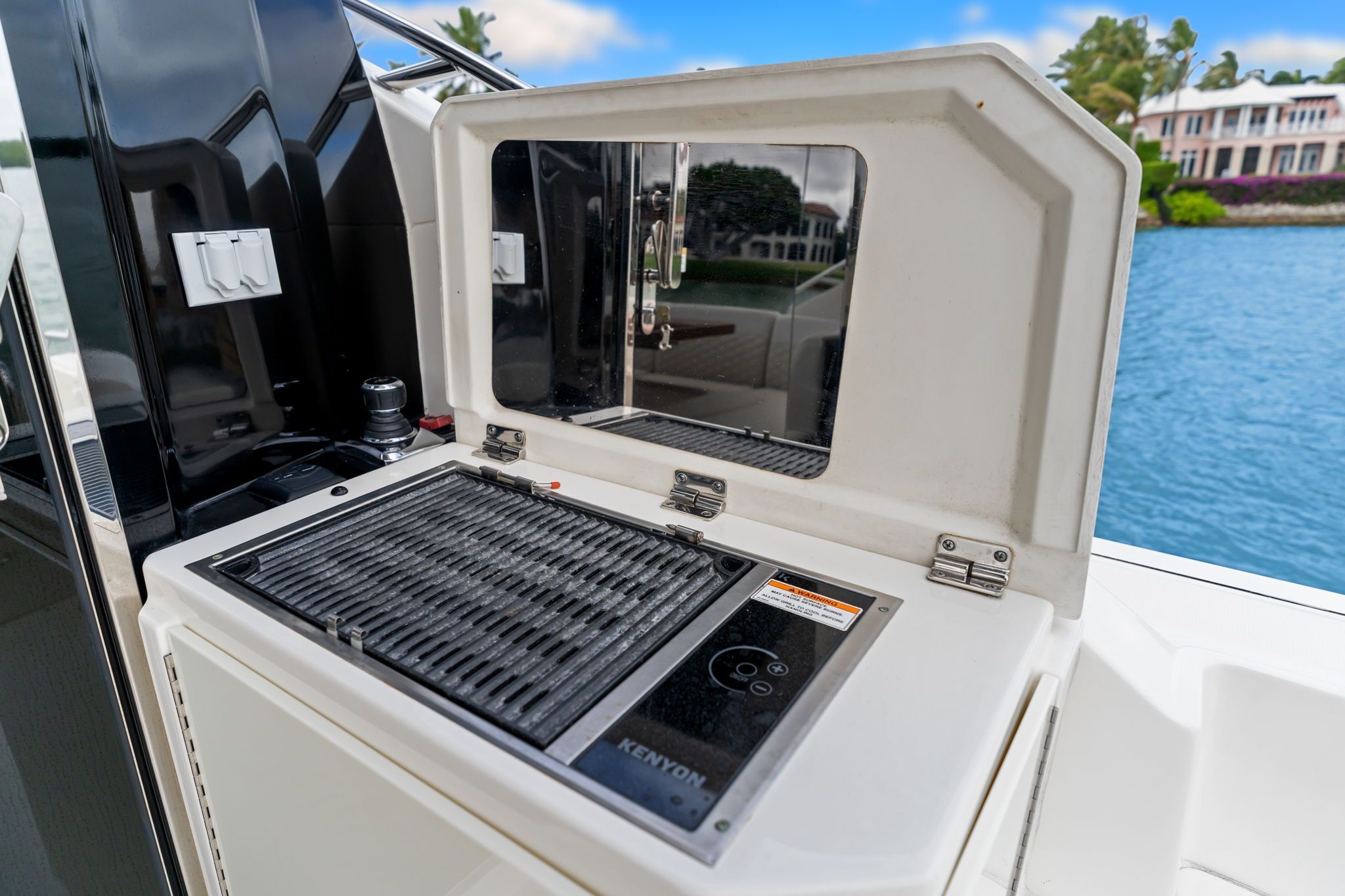 Outdoor kitchen with grill on a Sea Ray Sundancer 510 yacht, overlooking the water.