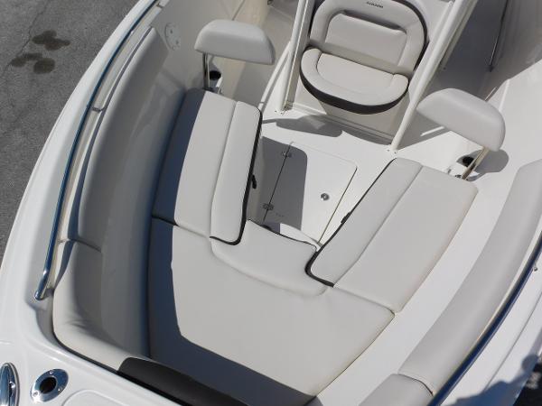 2024 Sailfish 242 CC boat interior with cushioned seating and storage compartment.