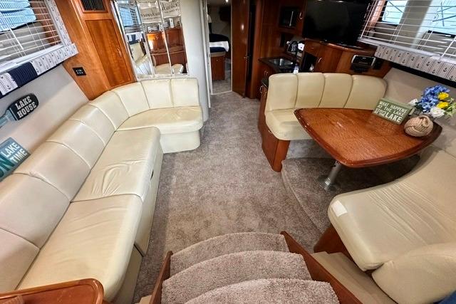 Luxurious interior of 2004 Carver 360 Mariner yacht with plush seating and elegant wood finishes.
