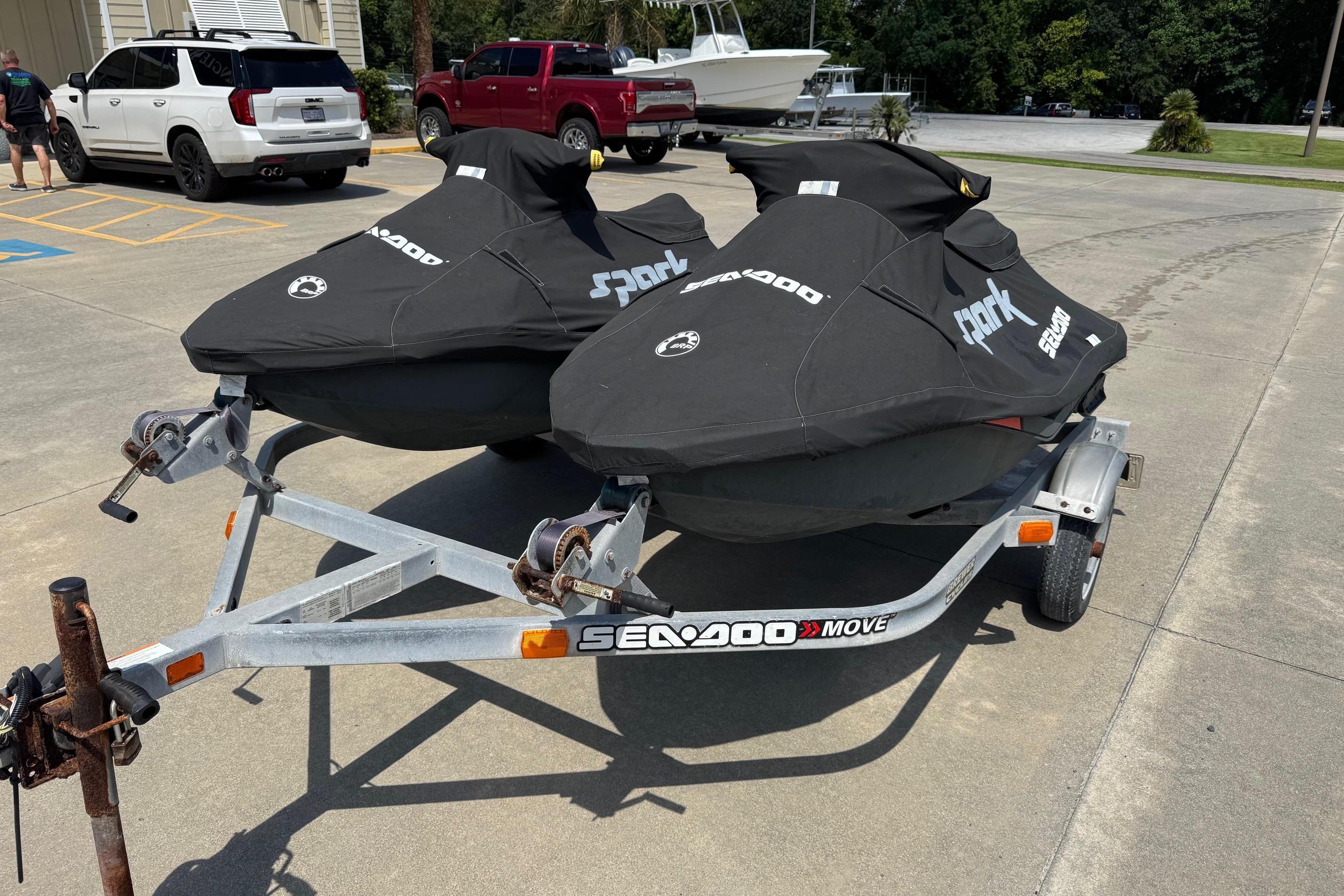 2017 Sea-Doo Spark 2up jet skis on trailer, covered and parked outdoors.