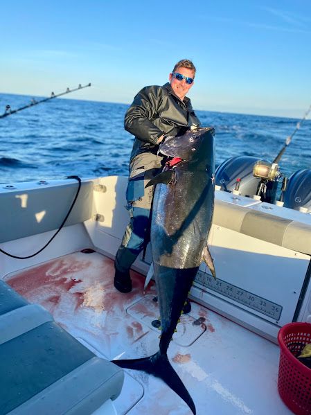 Angler with large fish on Cape Horn 32 XS boat, 2021.
