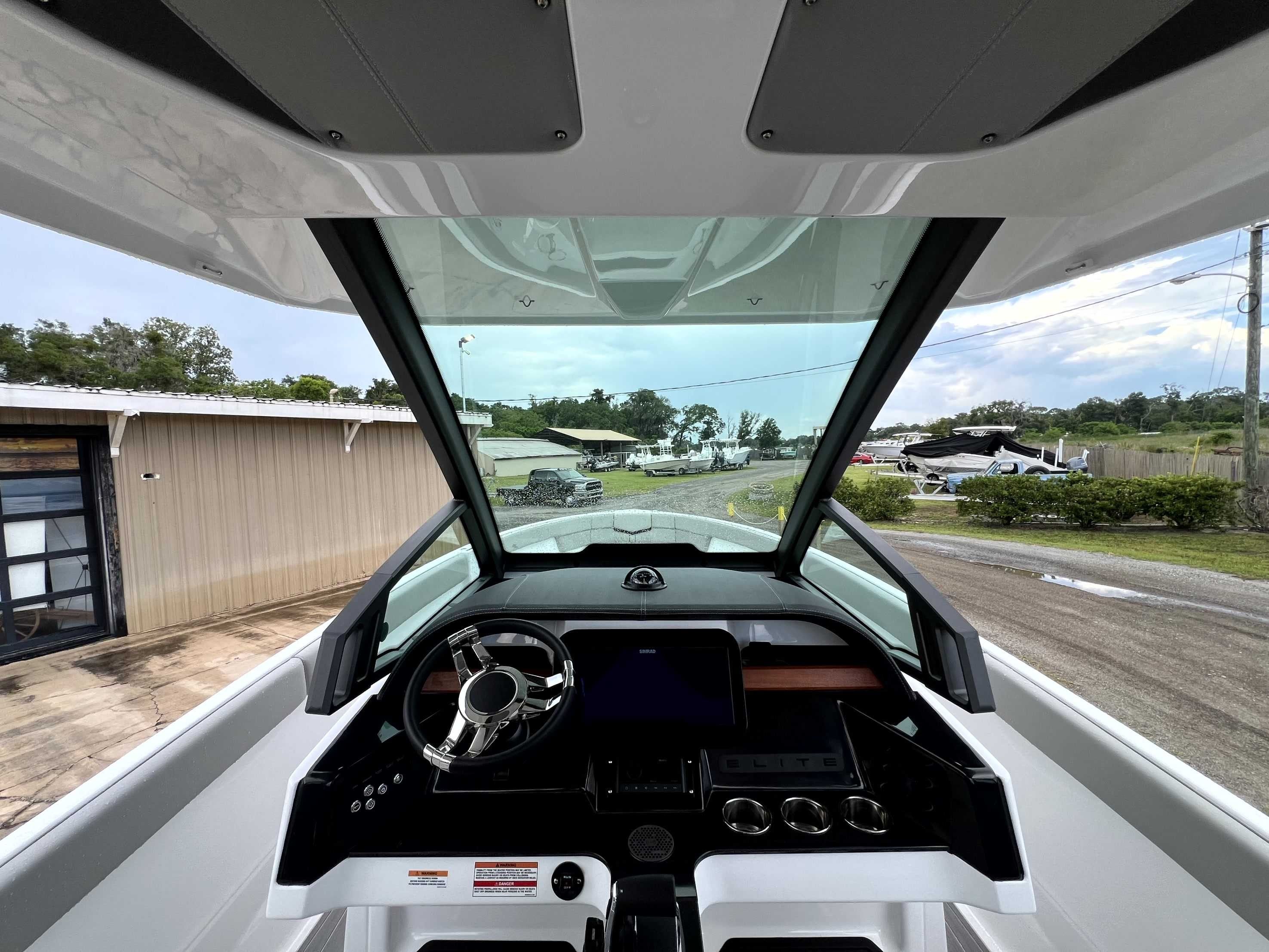 The cockpit of a 2026 Monterey Elite 25 with a modern steering wheel and instruments.