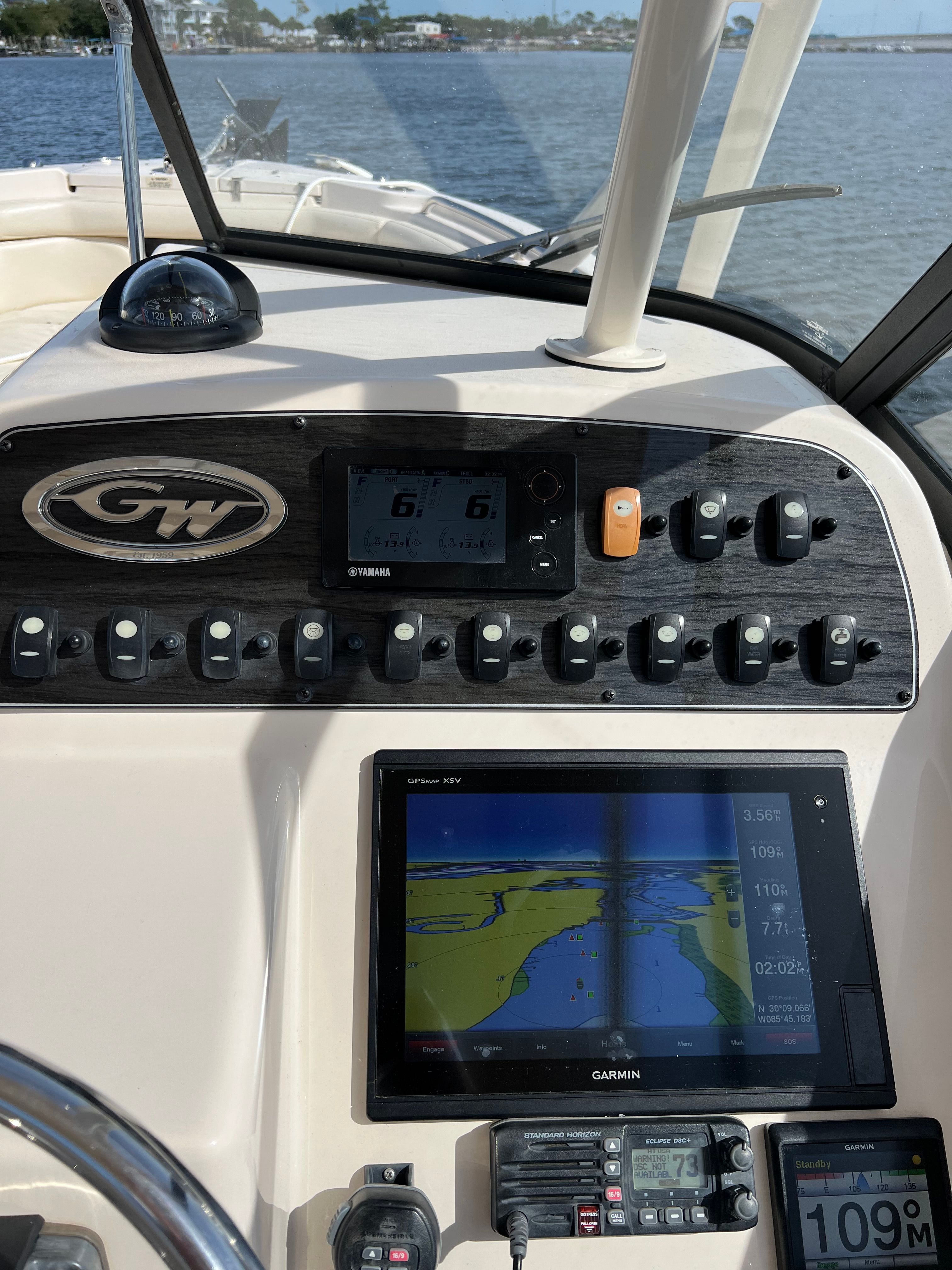 The dashboard of a Grady-White Freedom 275 boat with navigation system and controls.