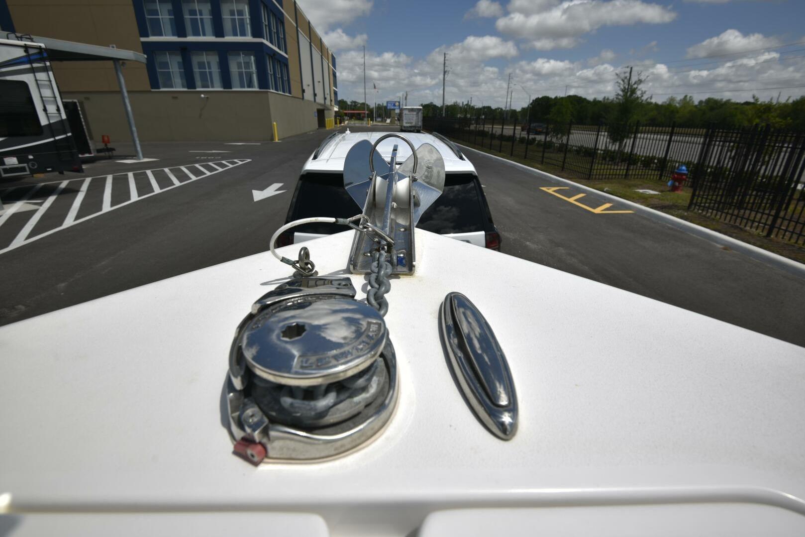 Bow view of 2023 Sea Pro 239 Deep V CC boat on trailer.