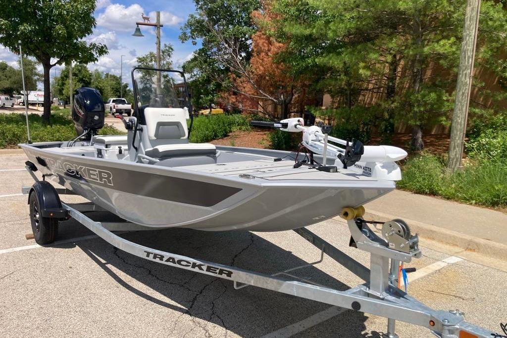 2026 Tracker Bass Tracker Classic CC boat on trailer in sunny parking lot.