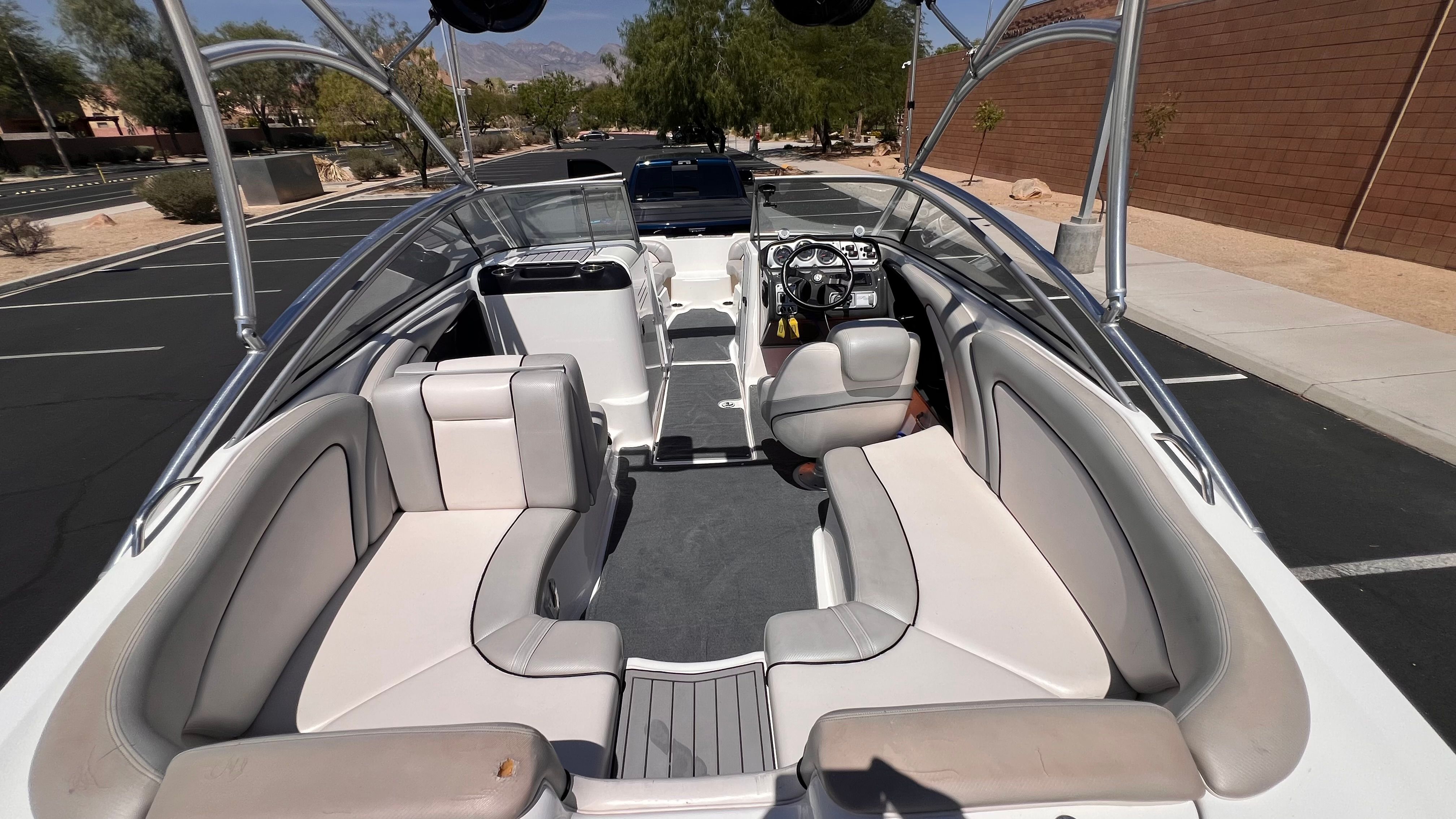Interior of a 2011 Yamaha AR240 HO boat in a parking lot.