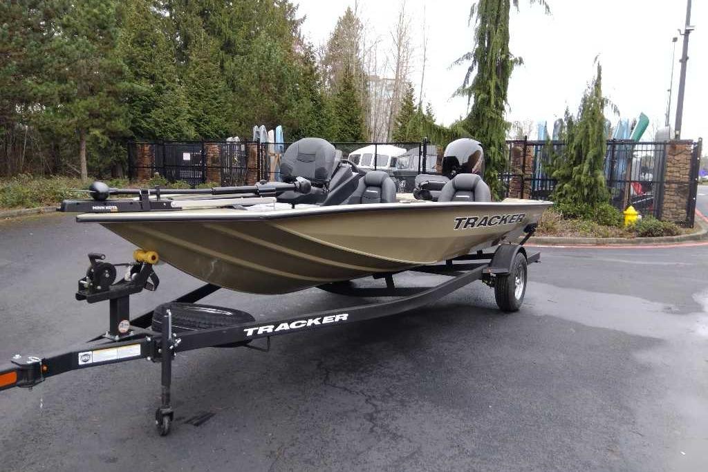 2026 Tracker Pro Team 195 fishing boat on trailer, parked outdoors.