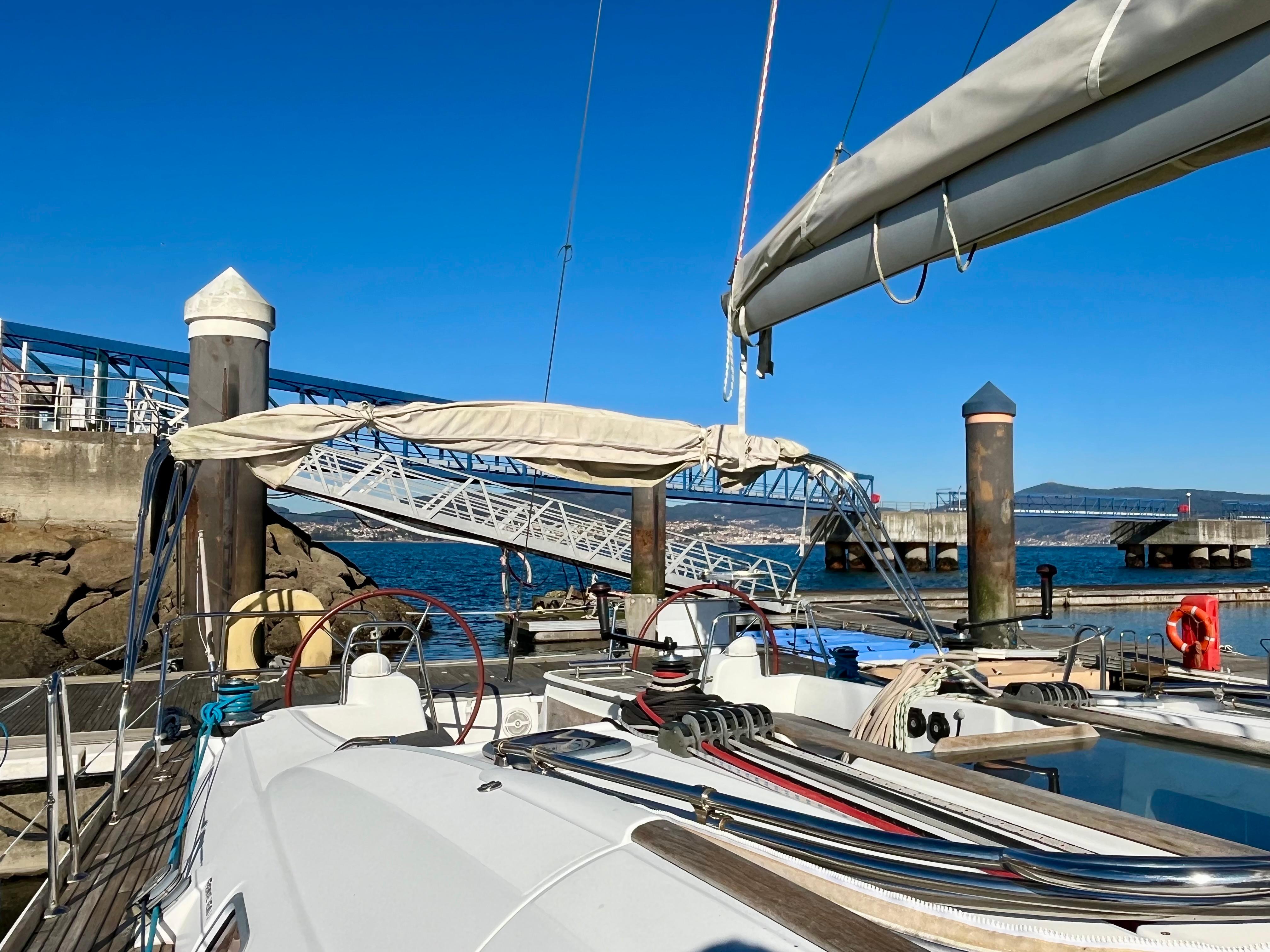 Beneteau Oceanis 46 sailboat docked at marina, clear blue sky, 2007 model.