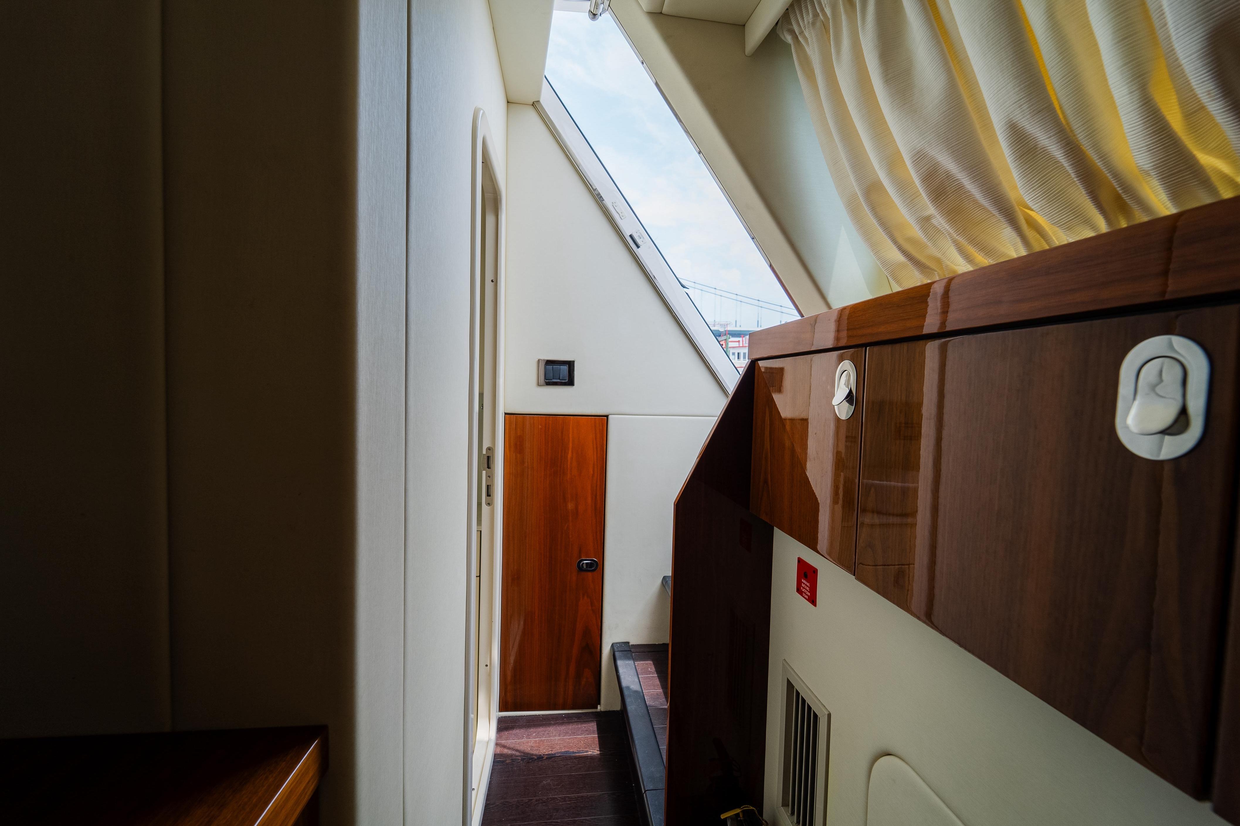 Interior hallway of 2016 Sunseeker Manhattan 65 yacht with wooden cabinetry and natural light.