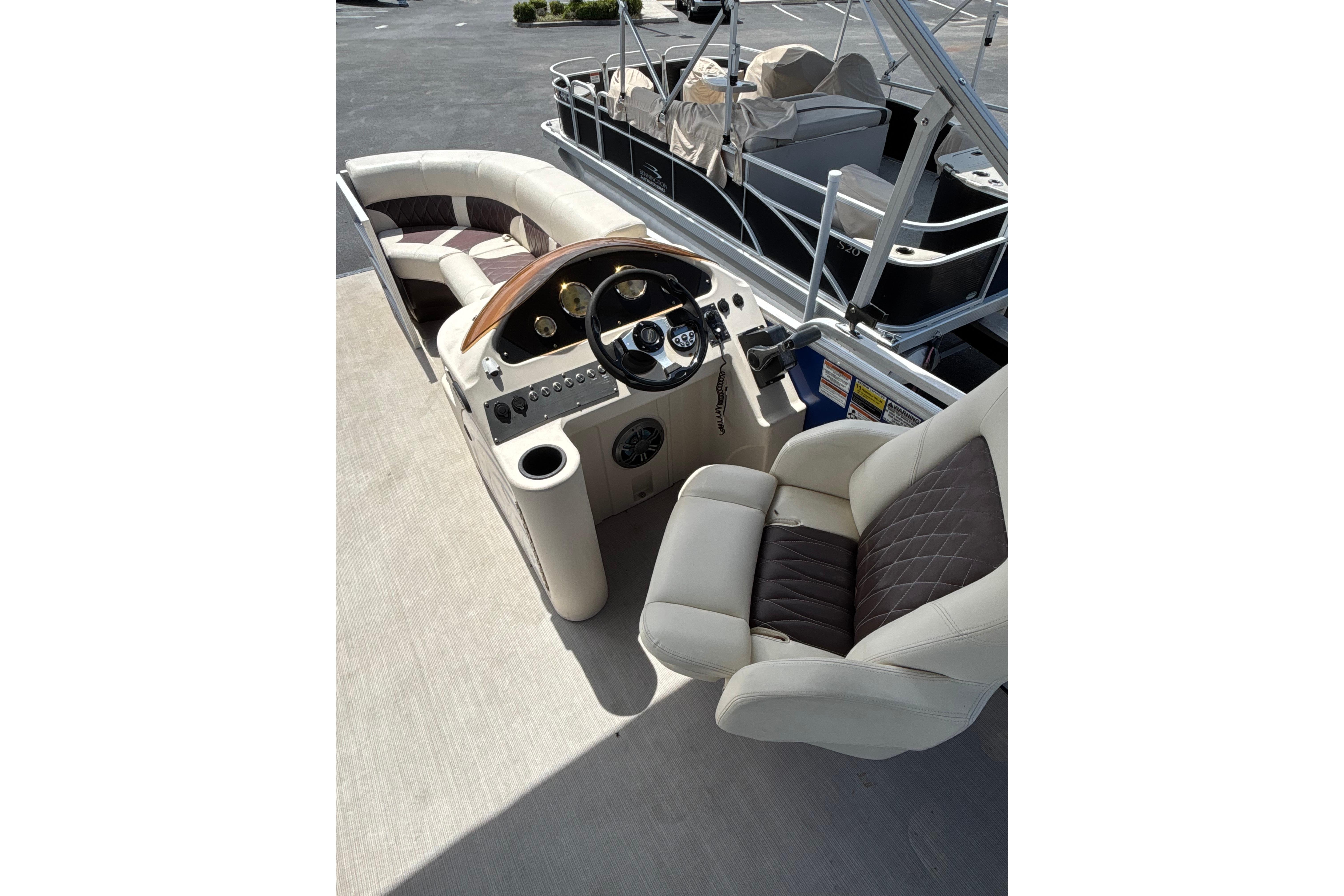 Luxurious 2022 Lexington 323 boat interior with plush seating and modern dashboard.
