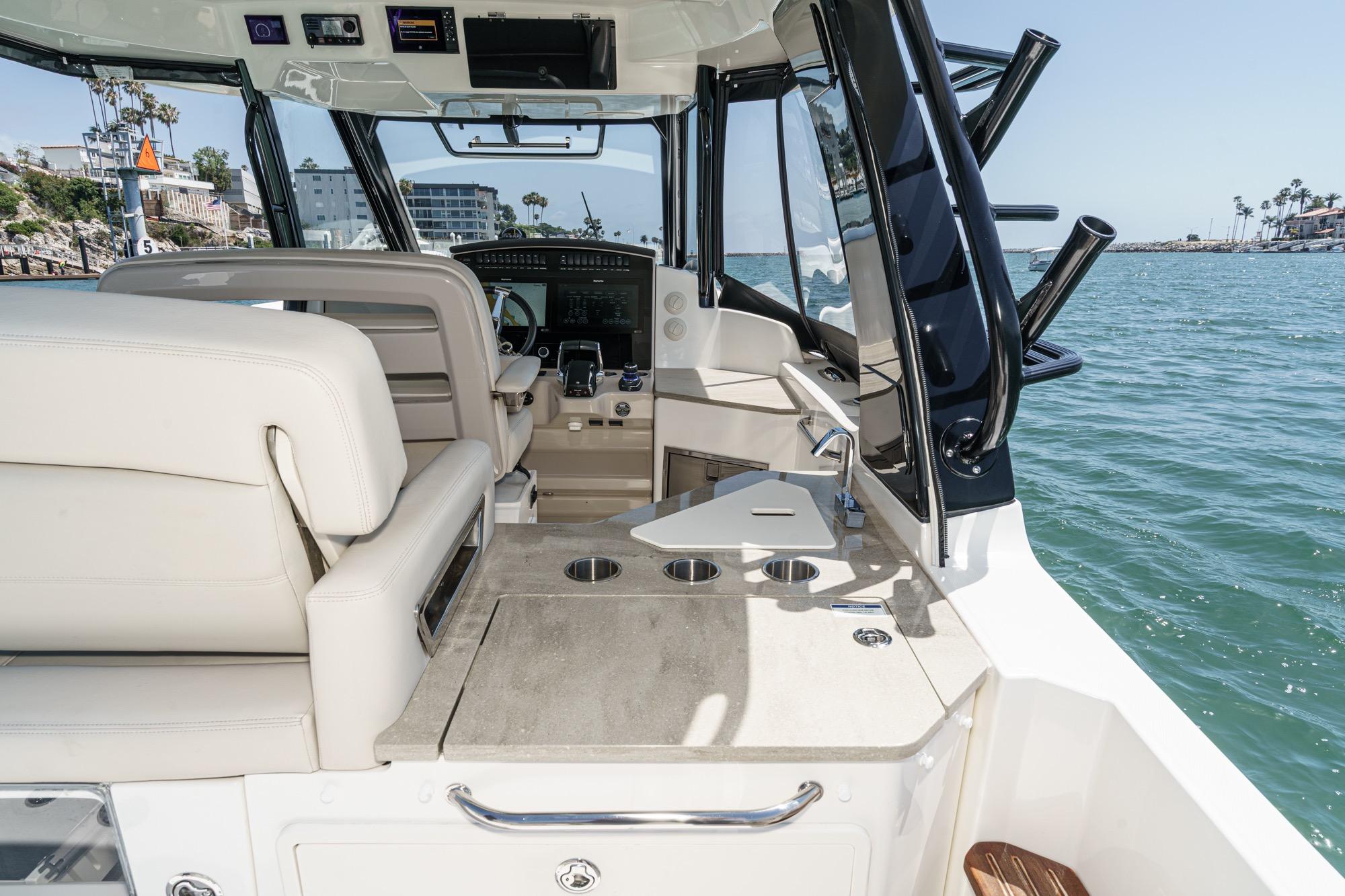 2023 Boston Whaler 350 Realm boat interior with helm, seating, and ocean view.
