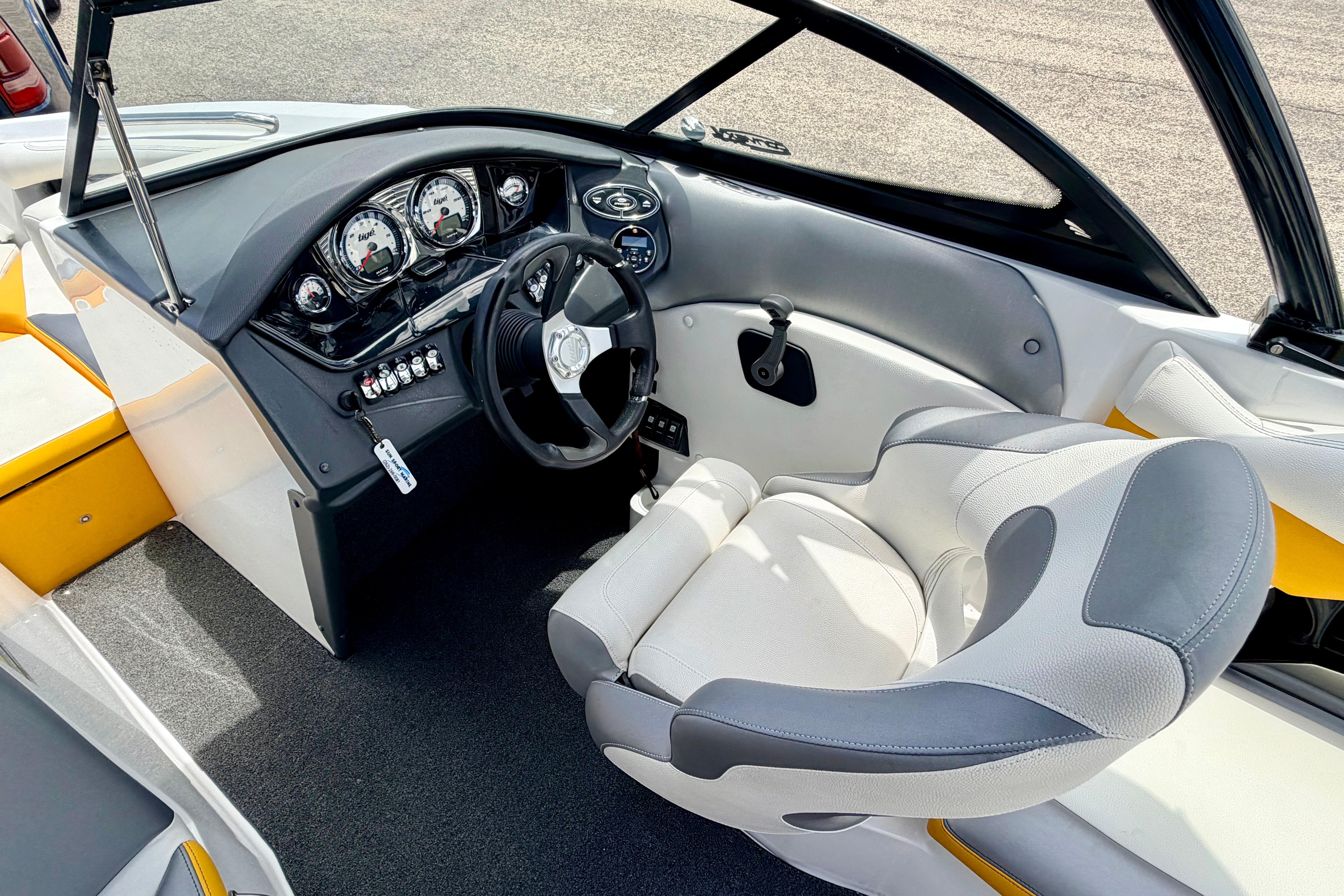 Interior of a 2014 Tigé R20 boat featuring a sleek dashboard and comfortable seating.