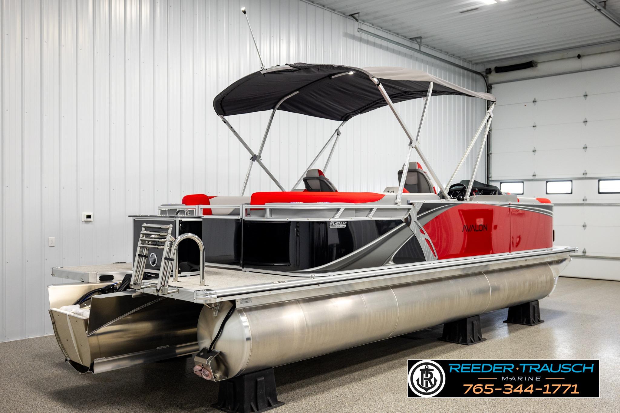 2026 Avalon LSZ QL pontoon boat with red accents in a showroom.
