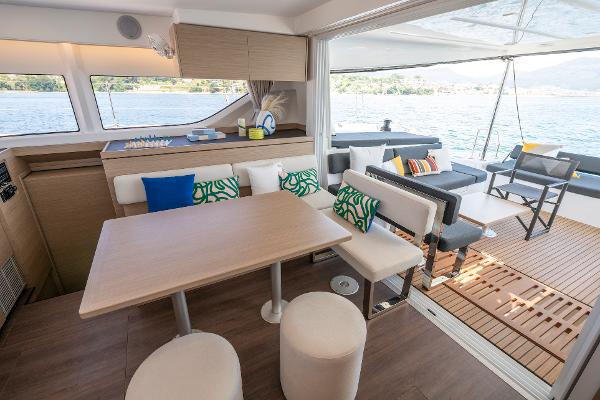 Luxurious interior of 2025 Lagoon 43 catamaran with modern seating and scenic ocean view.