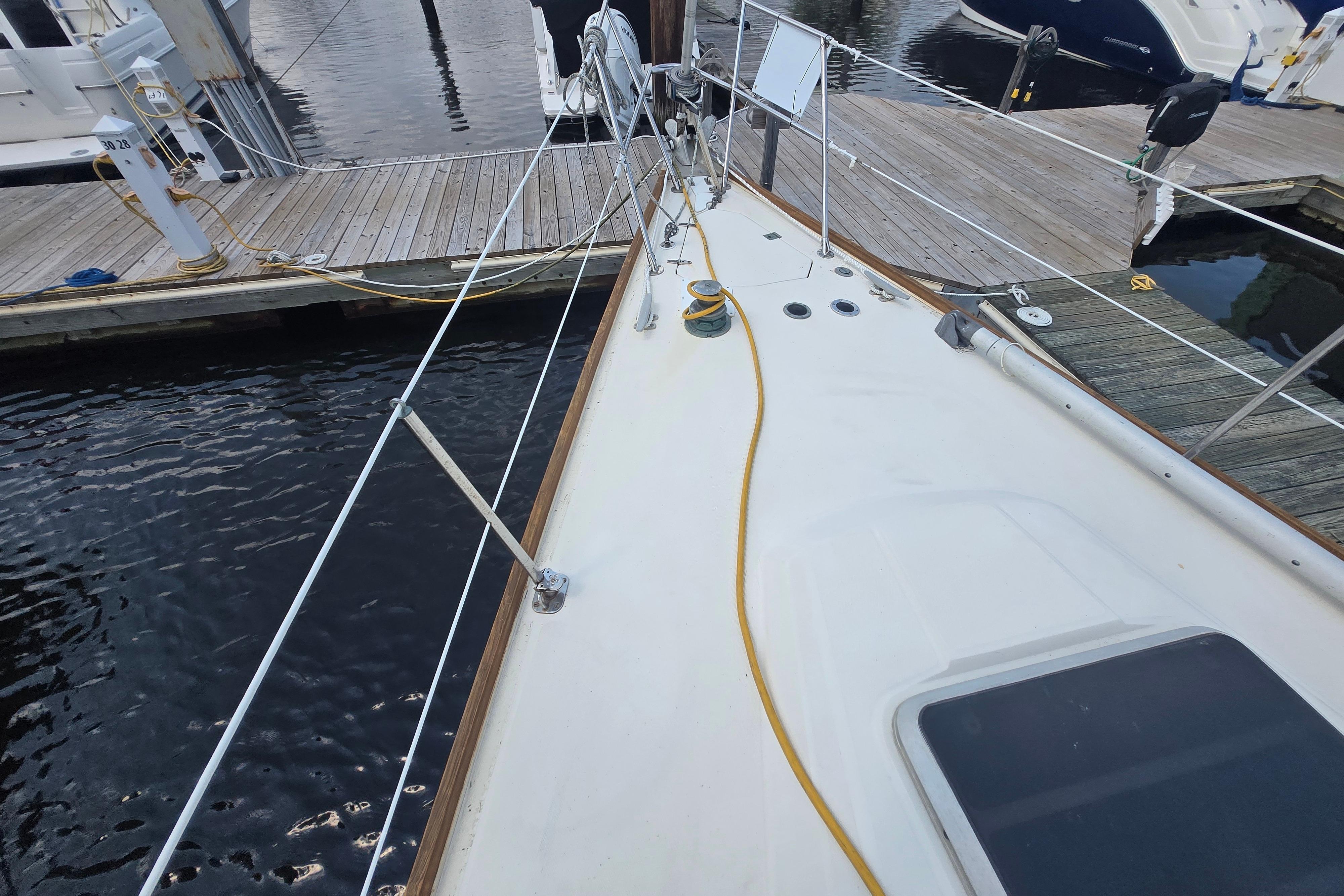 Deck view of a 1988 Sabre 38 sailboat docked at a marina.