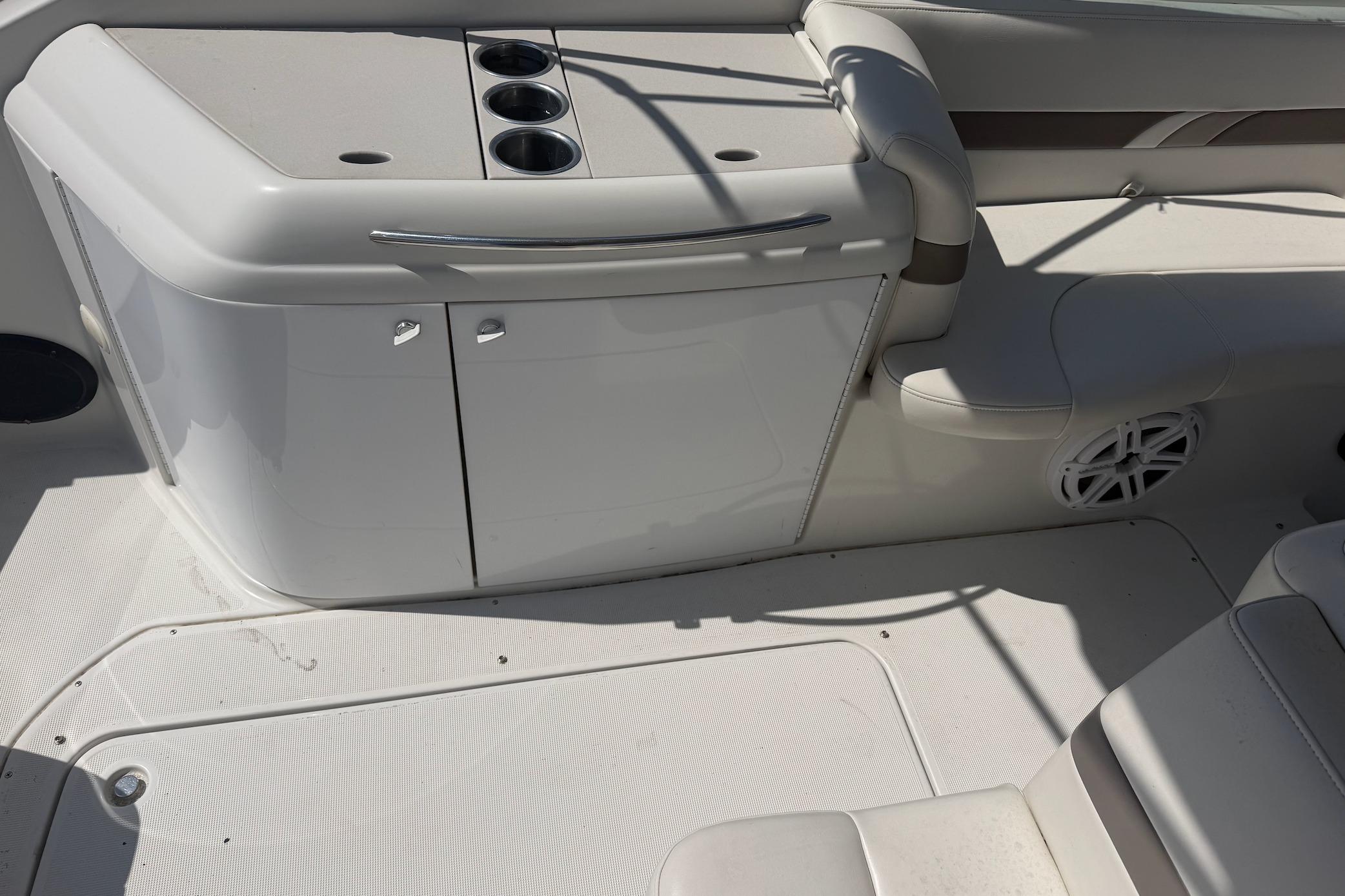 Interior of a 2002 Formula 280 Sun Sport boat, featuring seating and storage area.