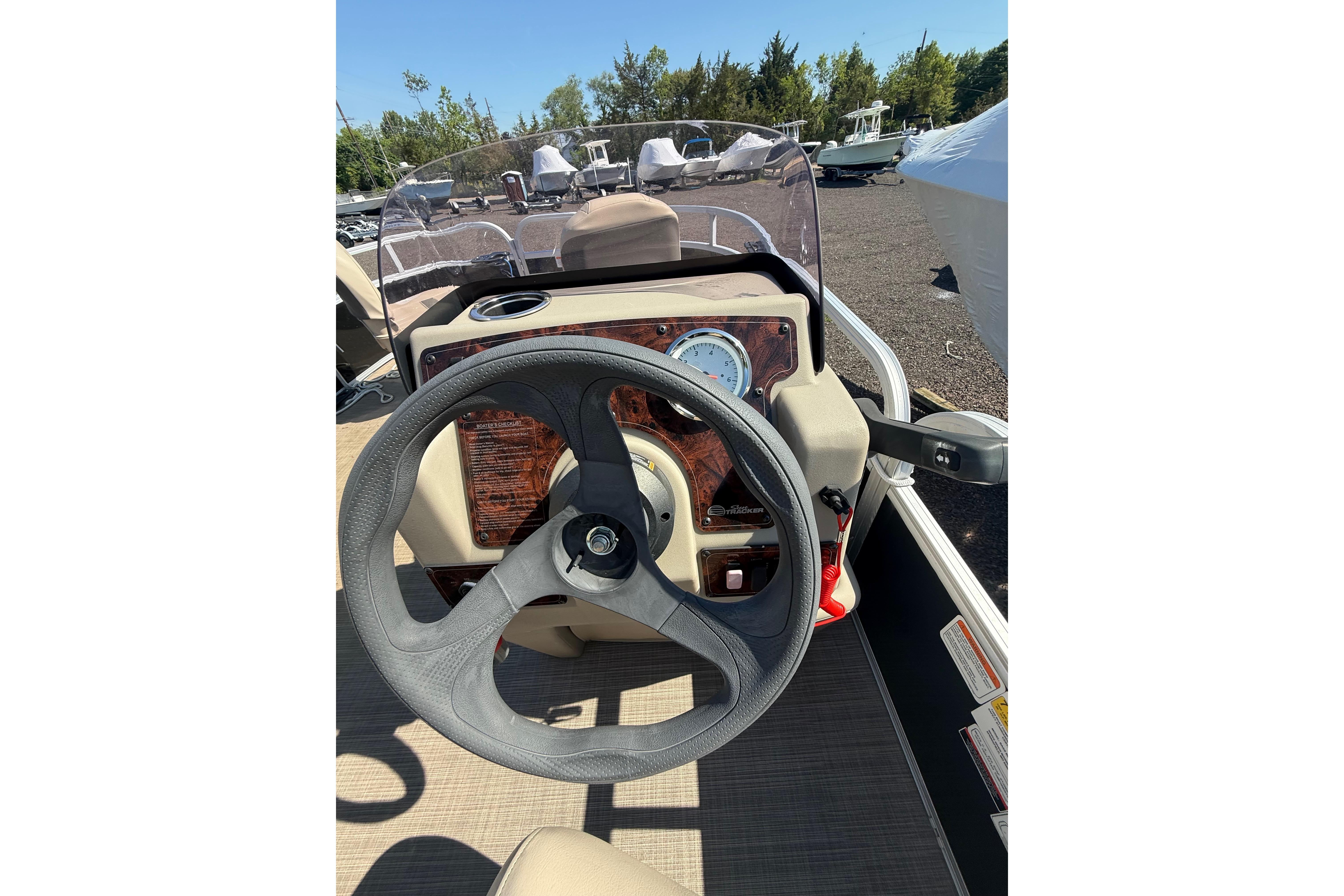 2021 Sun Tracker Bass Buggy 16 XL Select steering console with clear windshield and gauge.