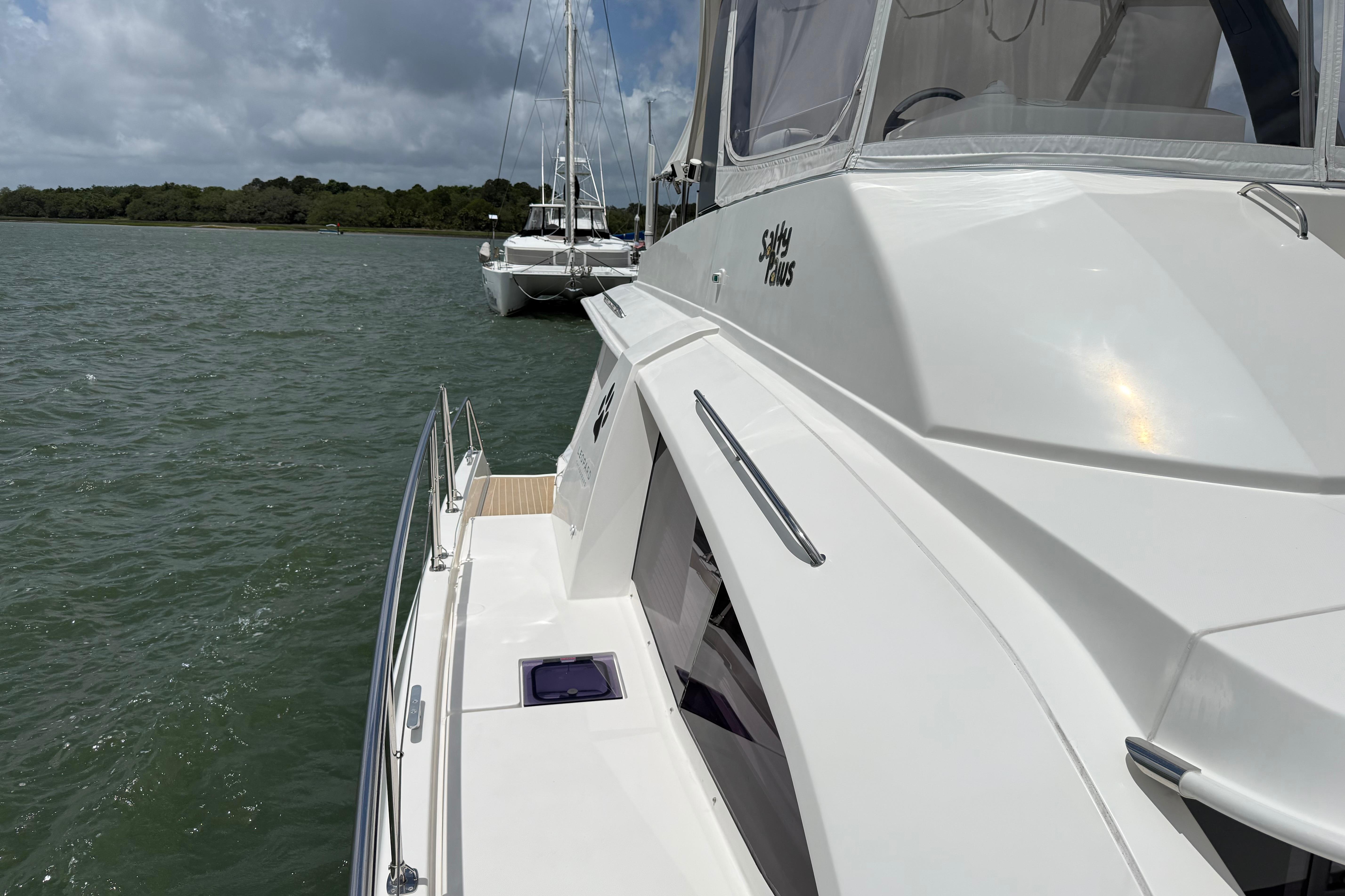 2021 Leopard 43 Powercat yacht docked on calm waters under cloudy skies.