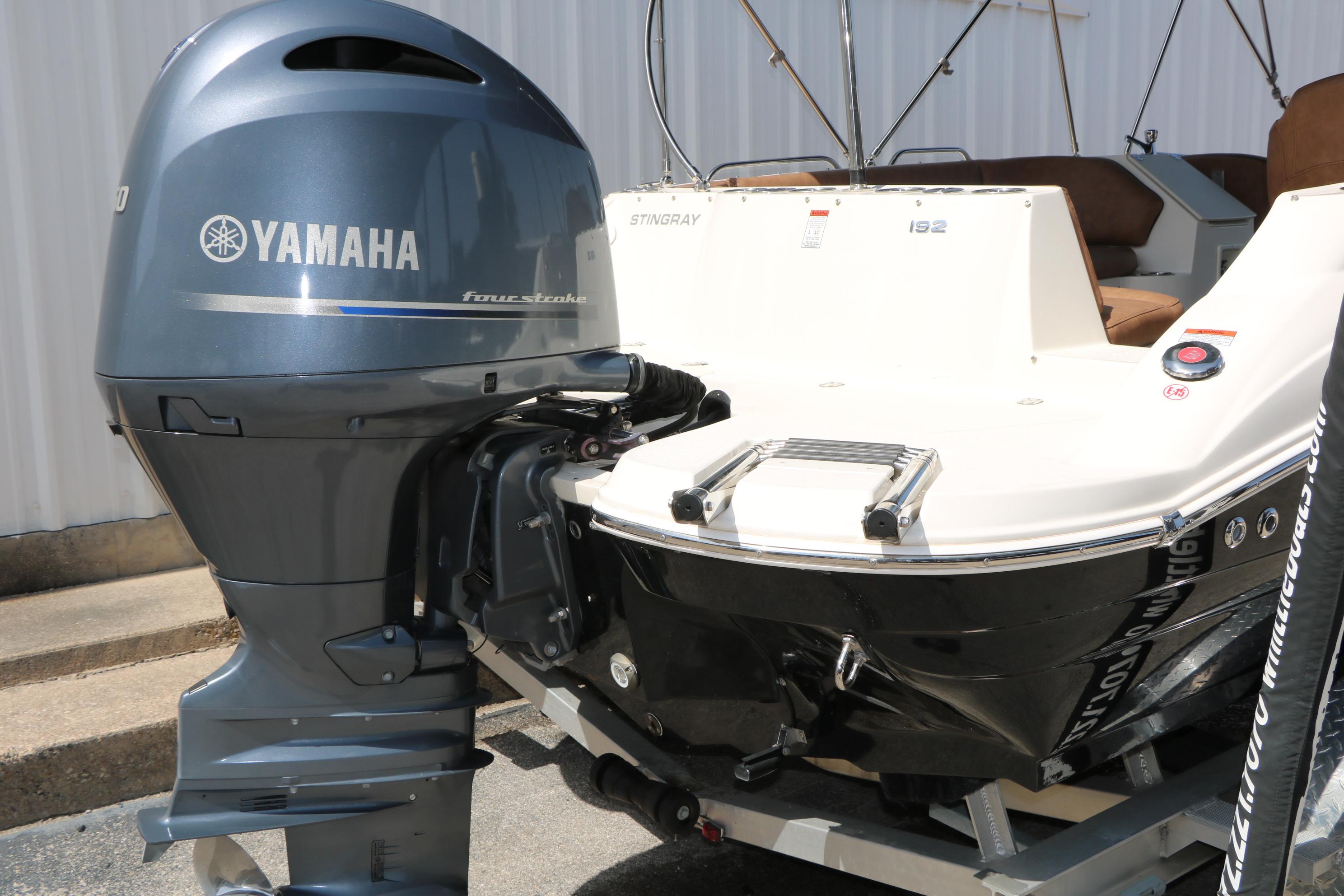 2022 Stingray 192 SC boat with Yamaha four-stroke outboard motor, rear view.
