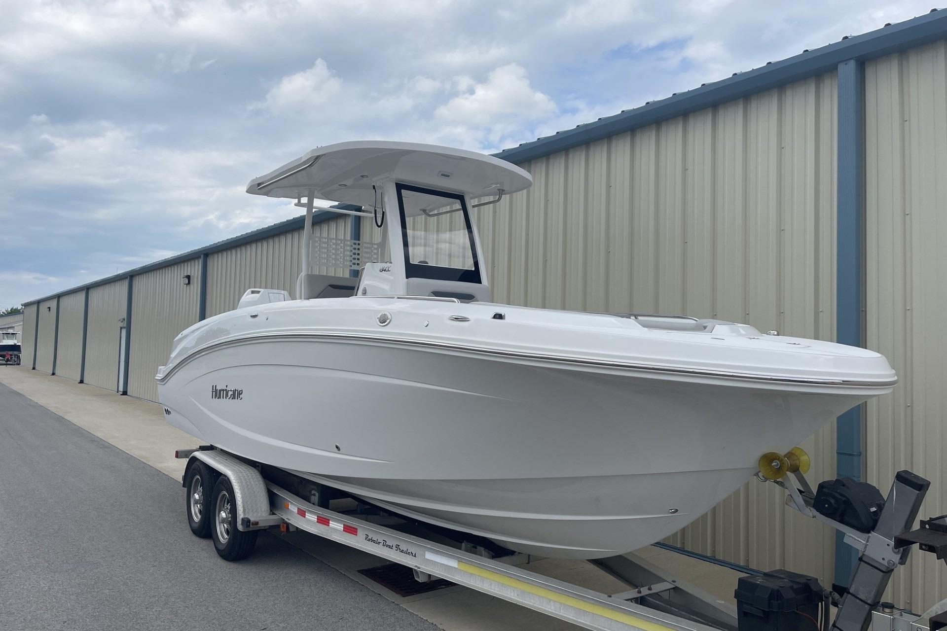 2026 Hurricane Center Console 24 OB boat on trailer, parked near storage facility.