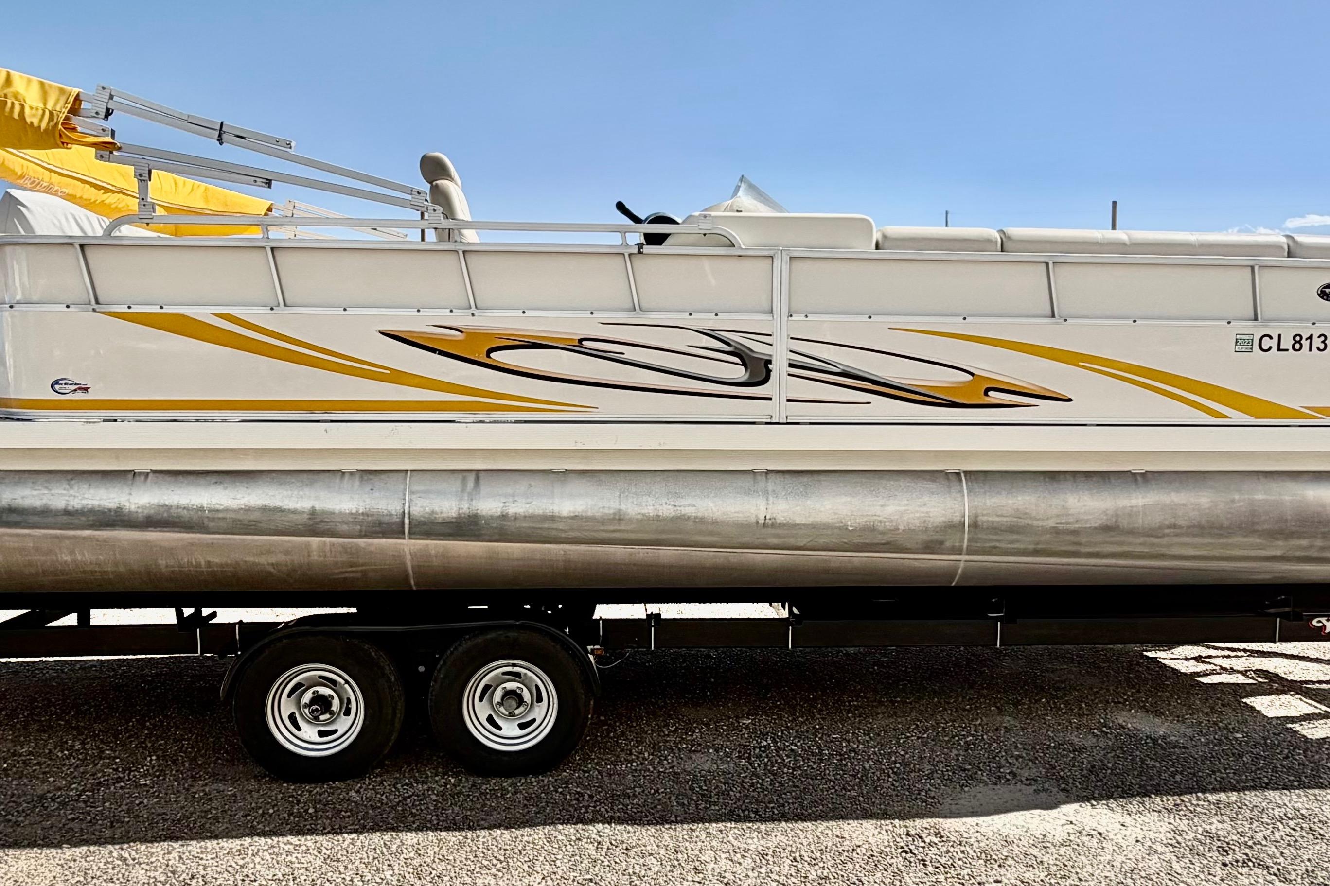 2006 South Bay 925CR pontoon boat on trailer with yellow and black graphics.