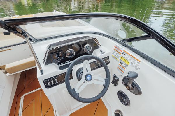 Manufacturer Provided Image: 2025 Bayliner D20 boat dashboard with steering wheel and control panel on water.