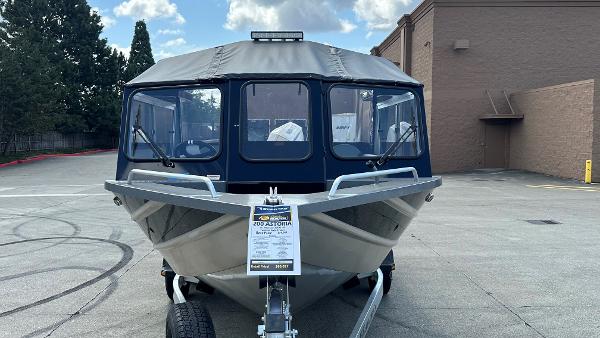 2024 Spartan 200 Astoria boat on trailer, parked outdoors, front view.